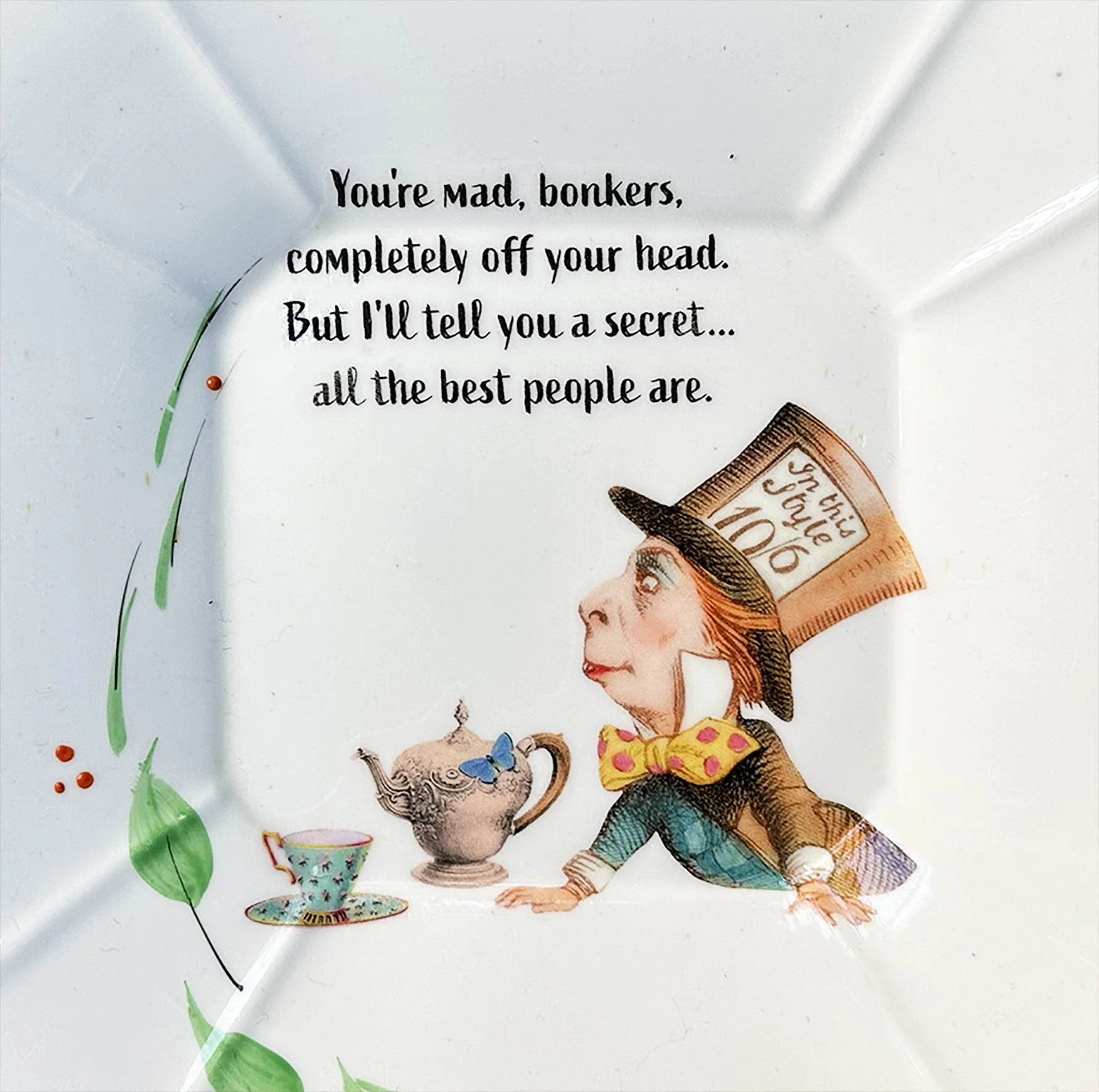 A vintage plate with a picture of the mad hatter and the quote “You’re mad, bonkers, completely off your head”