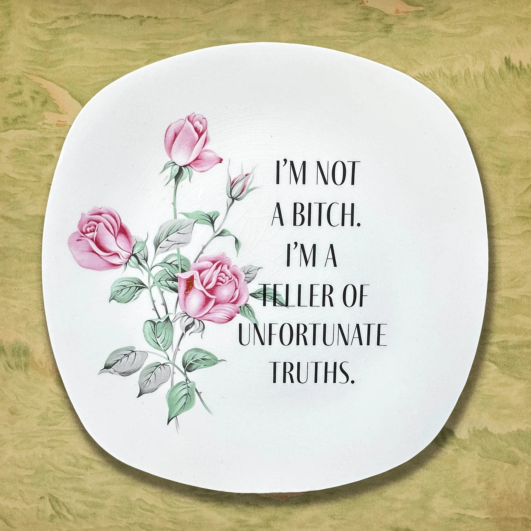 A vintage plate with a cheeky quote “I’m not a bitch. I’m a teller of unfortunate truths.”