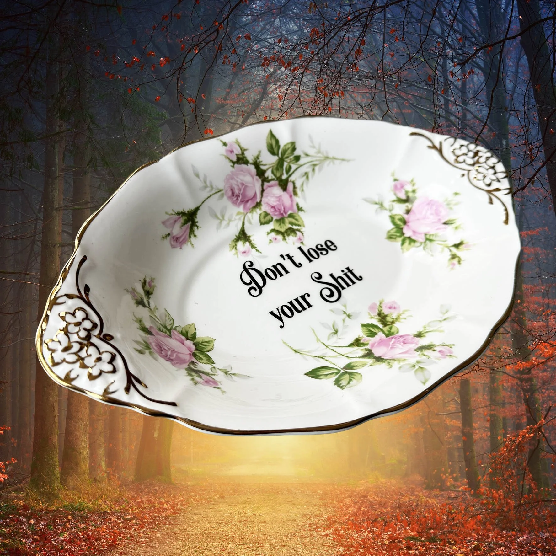 A vintage trinket dish with a pink floral design and the words “don’t lose your shit”
