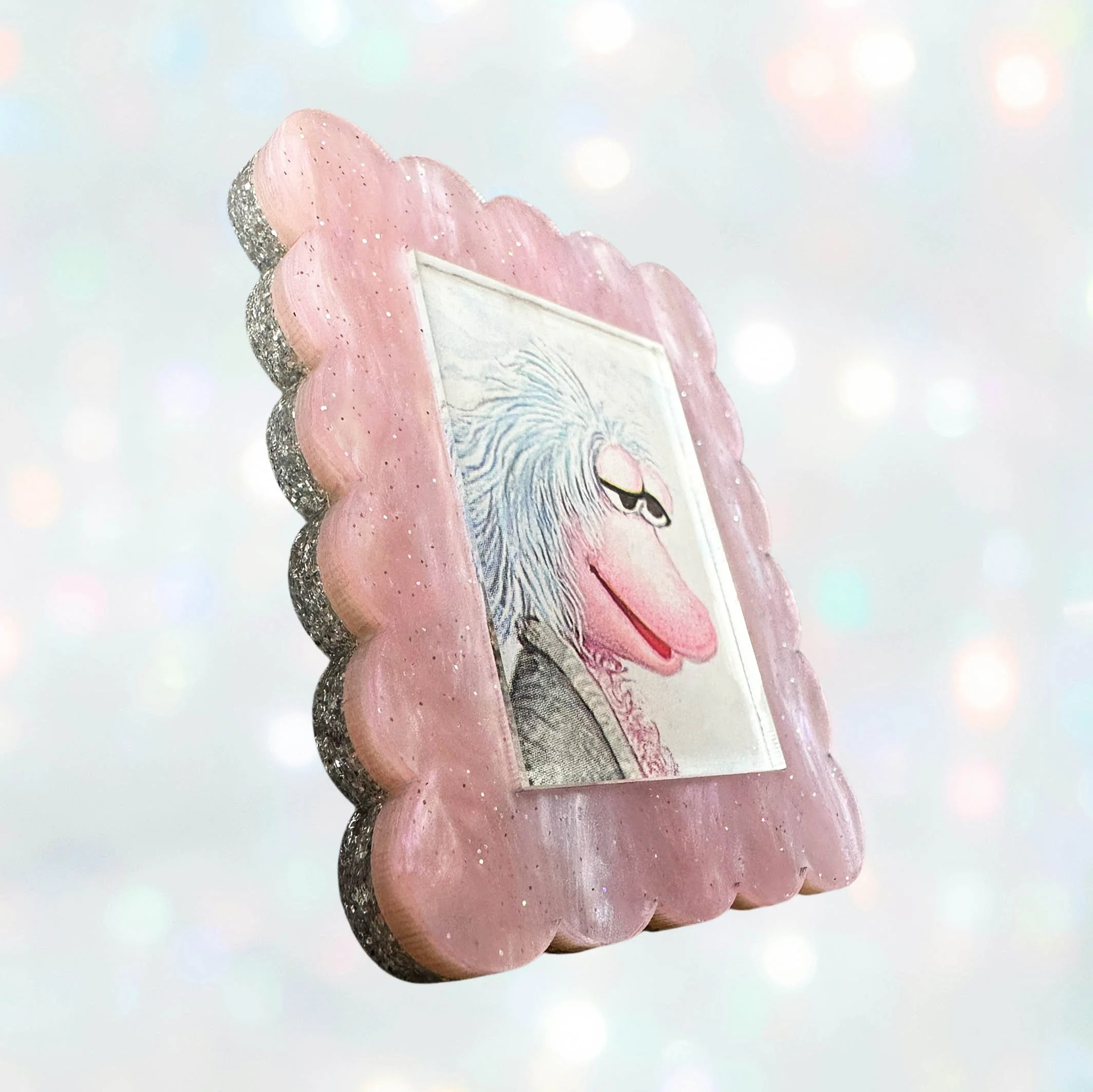 Pink glitter acrylic brooch featuring Mokey from Fraggle Rock