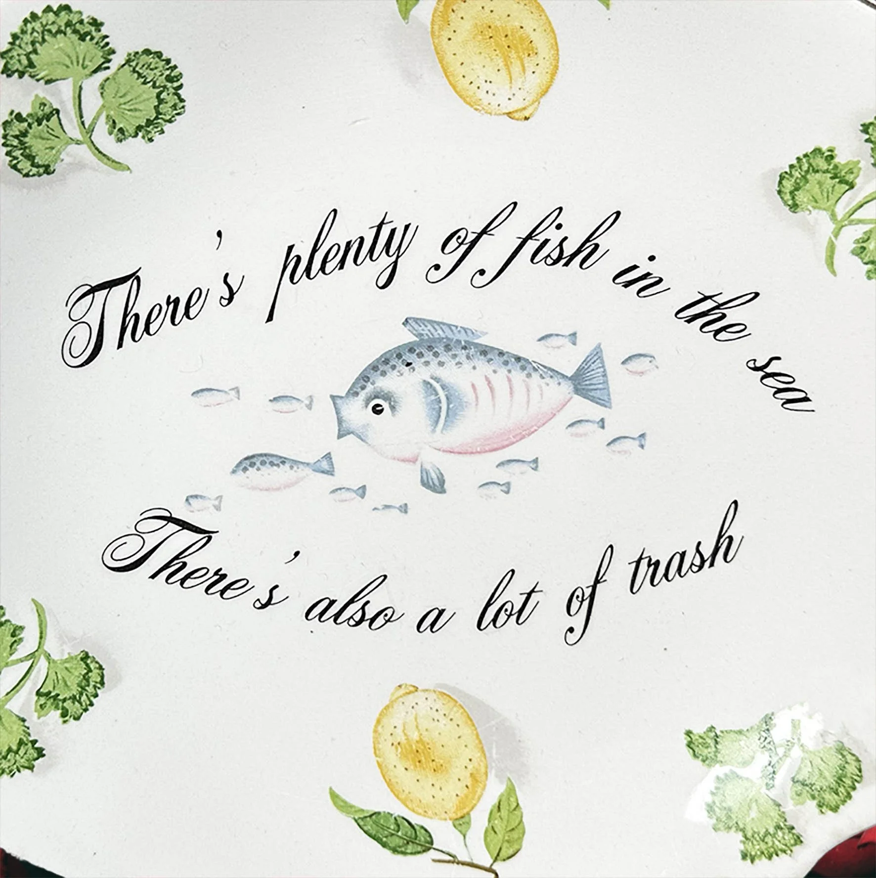 A vintage fish shaped dish with a quote “there’s plenty of fish in the sea, there’s also a lot of trash”