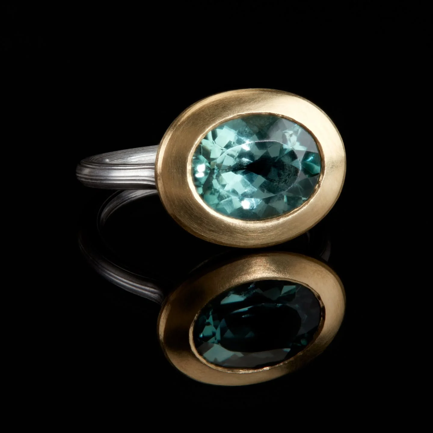 Uplifting, ocean toned tourmaline in my newest ring form. With a rounded back,  ribbed silver band, and wide gold setting, this ring sits low to the hand and has a pleasing tactile feel. 

If you're visiting @goldsmithsfair this week,  drop by and tr