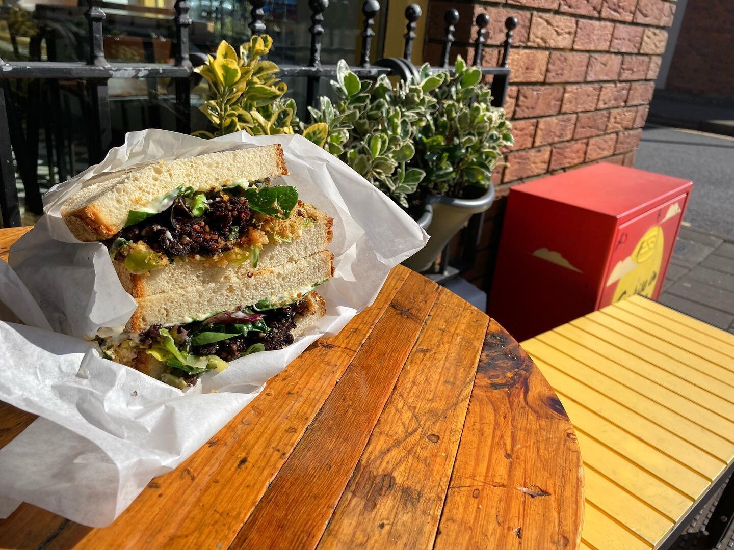 The Black Pudding Sambo looking good in the sun. 
Made up of @clonakilty_blackpudding with hot buttered leeks, sage and onion stuffing, mayo and mixed leaves; it is just one of our delicious takeaway lunch options on our Spring menu! 
Sunny days and 