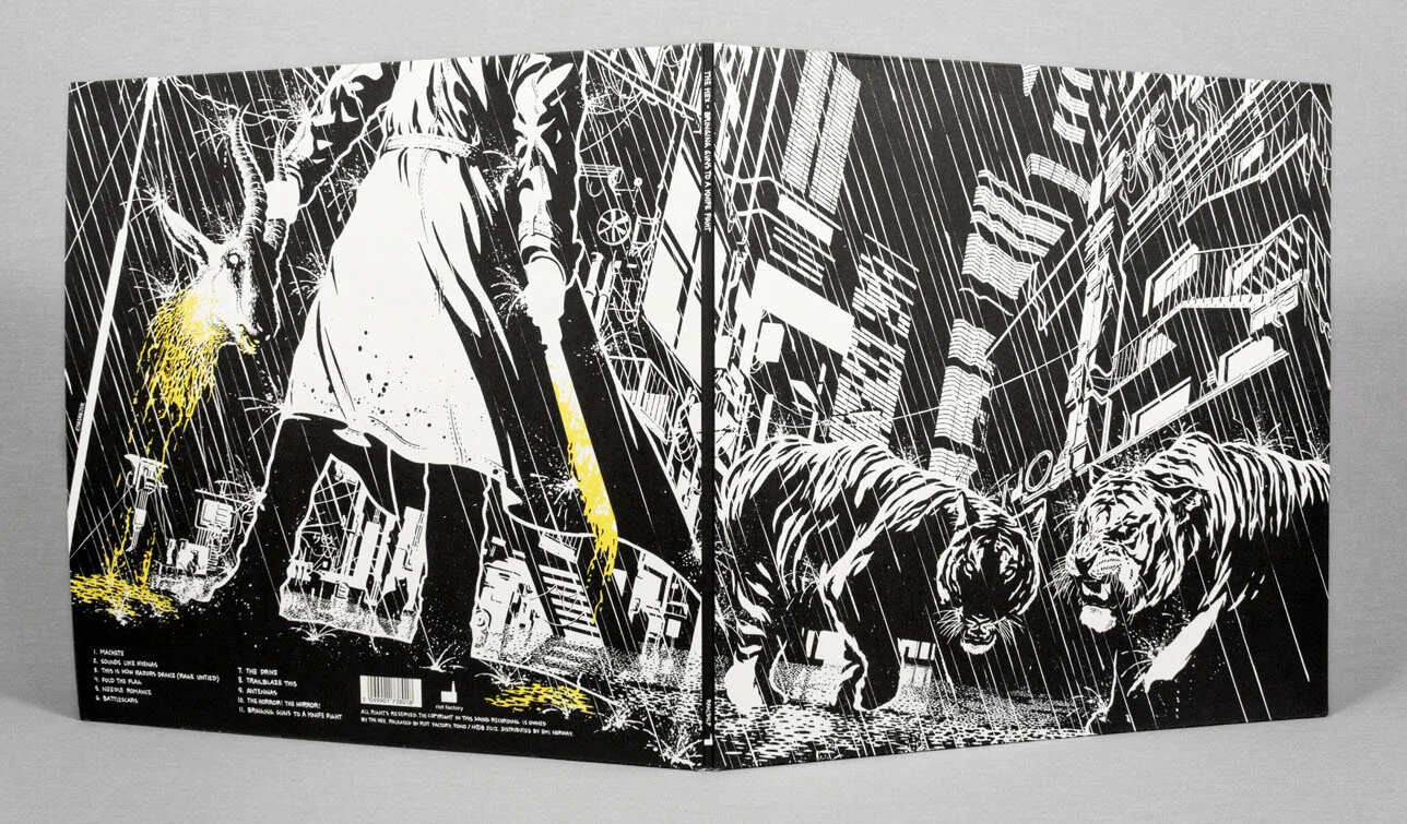 Black and white graphic art on a booklet cover depicts a person holding an umbrella walking in rain and two tigers walking in rain in an urban cityscape.