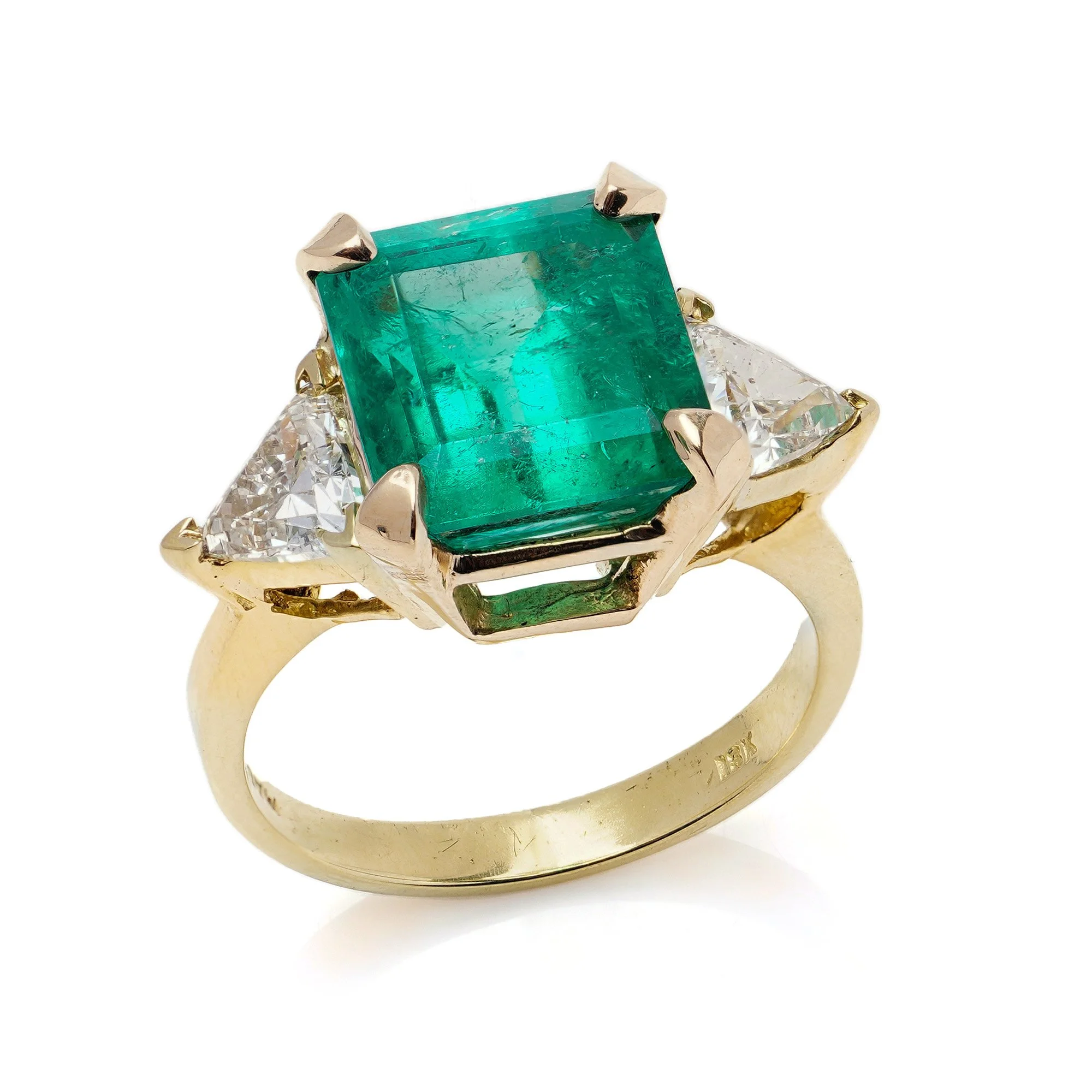 18kt yellow gold ladies ring with Natural 6.15 carat Colombian emerald and trillion-cut diamonds.