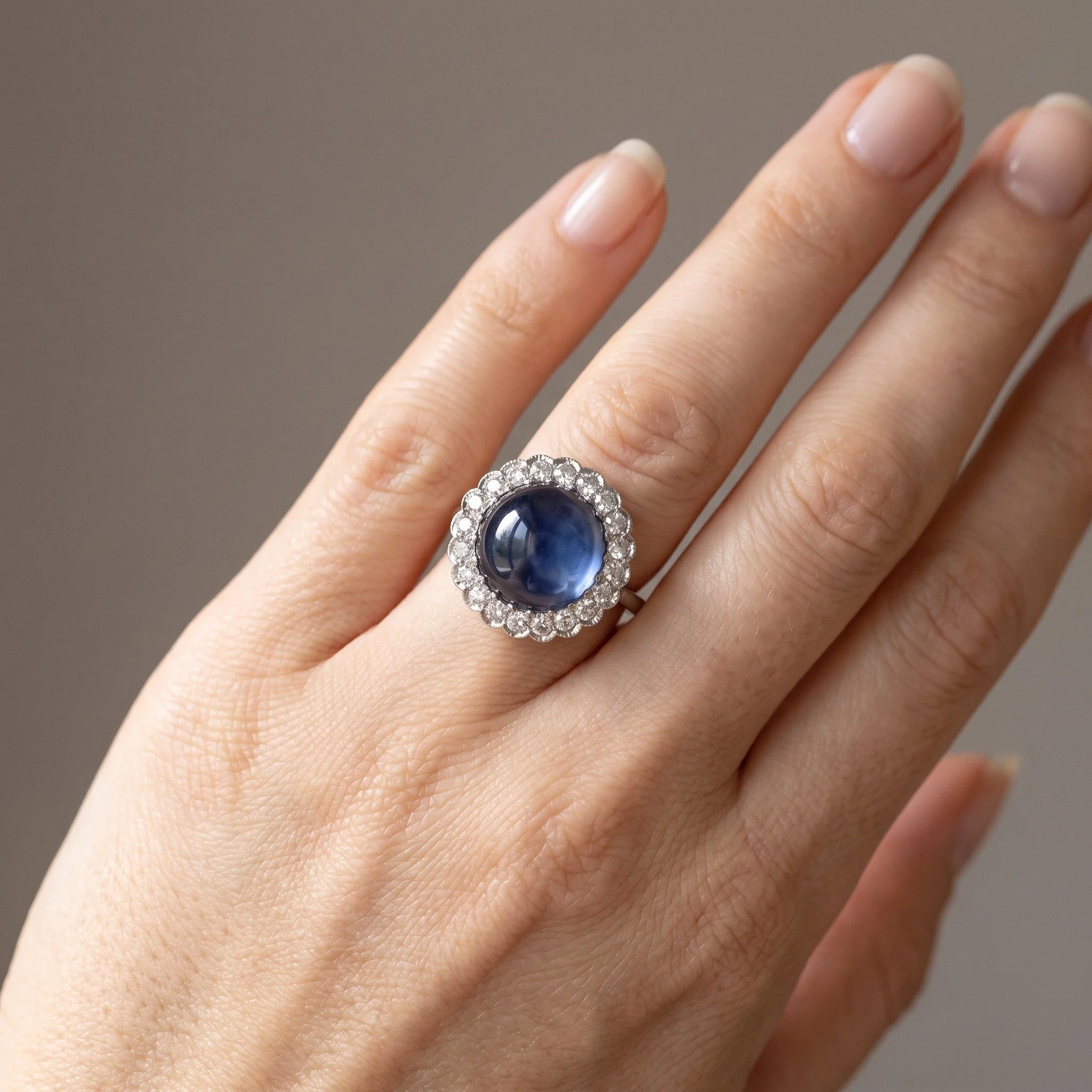 art-deco-platinum-cabochon-sapphire-diamond-cluster-ring-4-00-ct-02-worn-Mozeris-Fine-Antiques.jpg