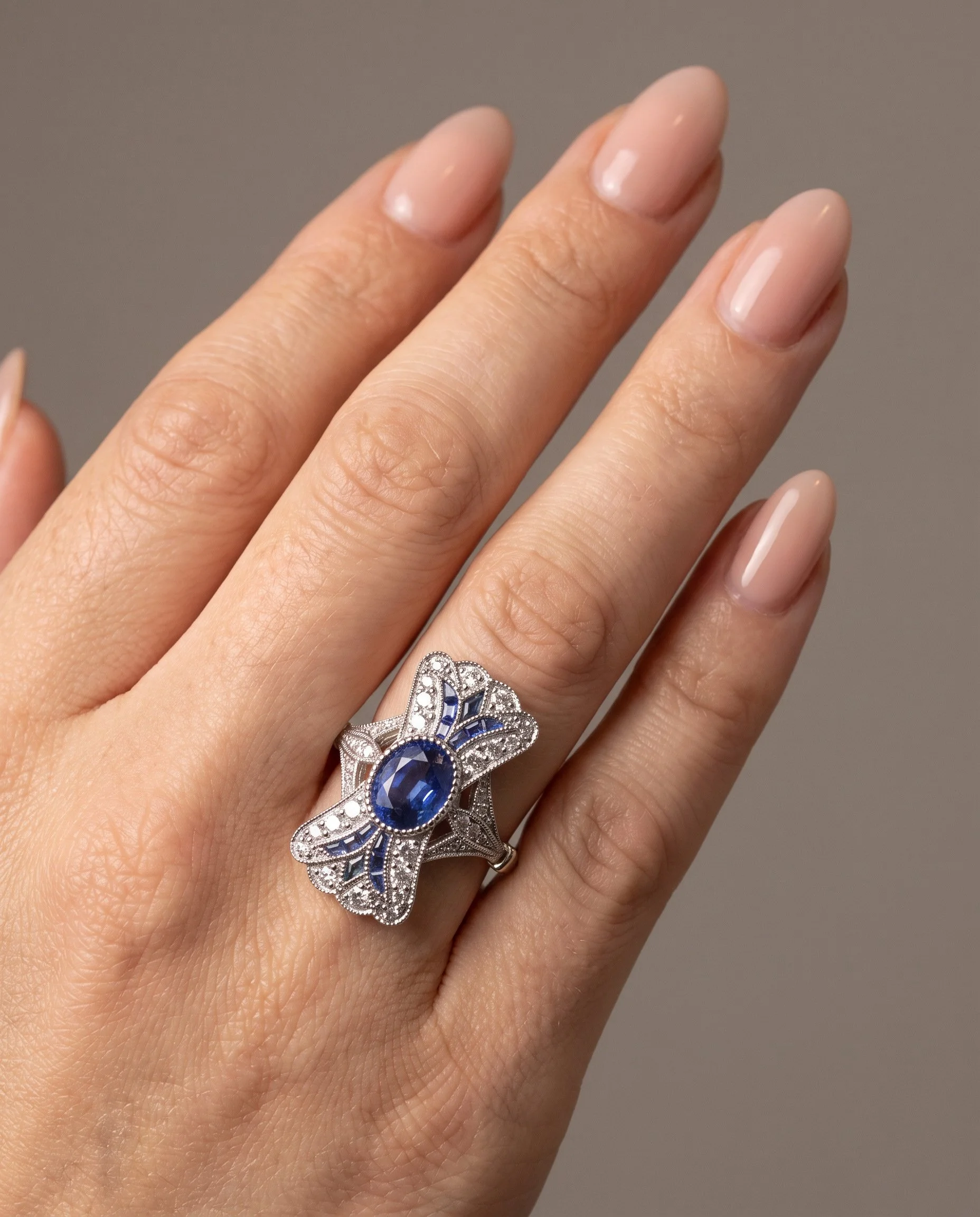 art-deco-style-platinum-111ct-sapphire-and-diamond-bow-plaque-ring-worn1-Mozeris-Fine-Antiques.jpg
