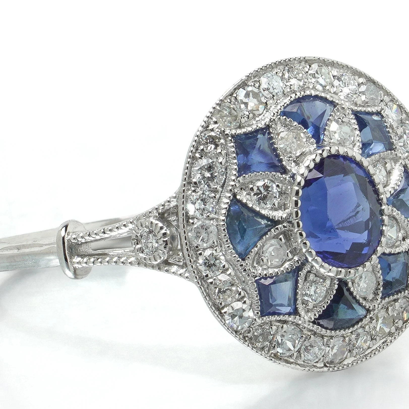 art-deco-style-platinum-sapphire-and-diamond-flowerhead-target-ring-07-angle-Mozeris-Fine-Antiques.jpg