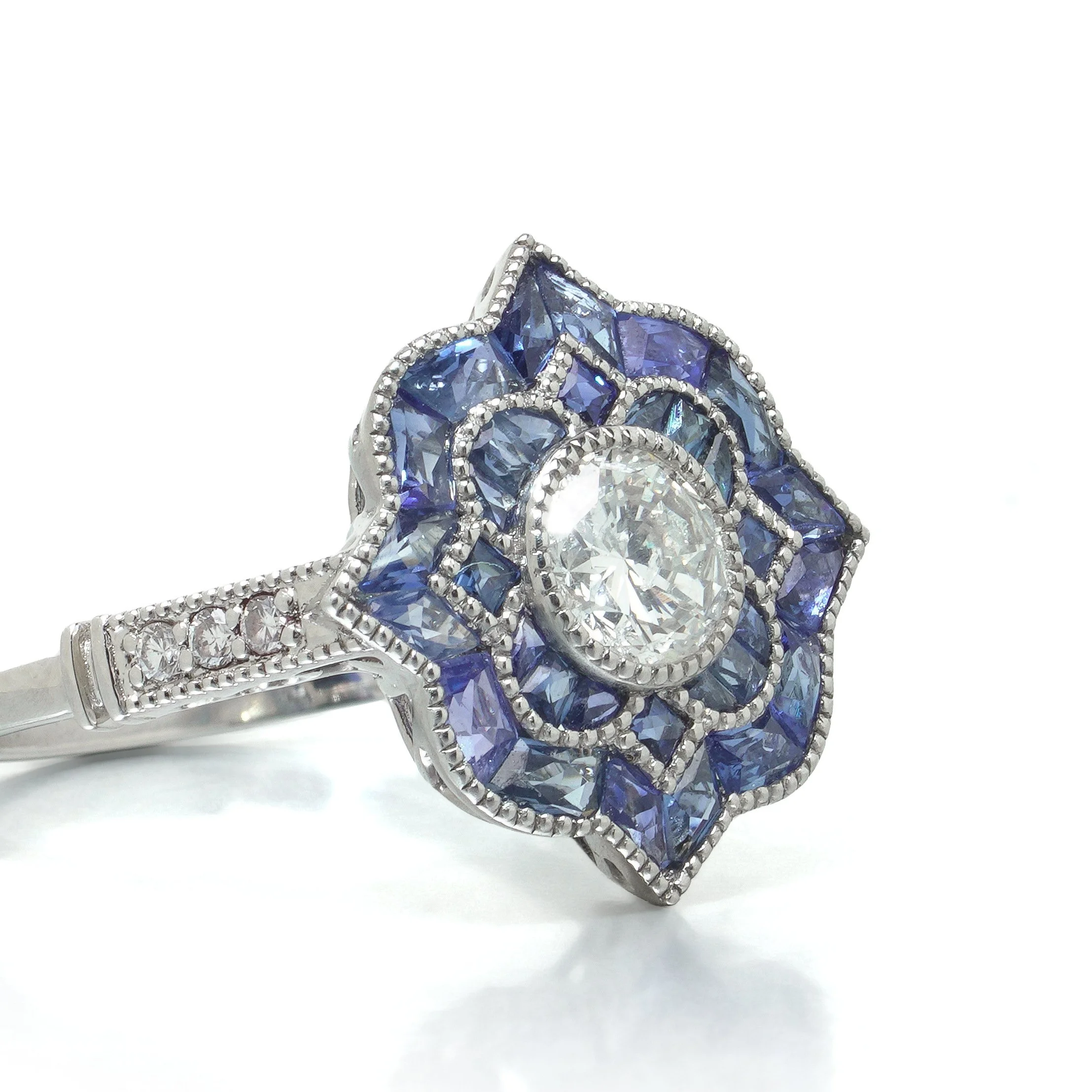 art-deco-style-platinum-diamond-and-calibre-sapphire-star-cluster-ring-07-angle-Mozeris-Fine-Antiques.jpg
