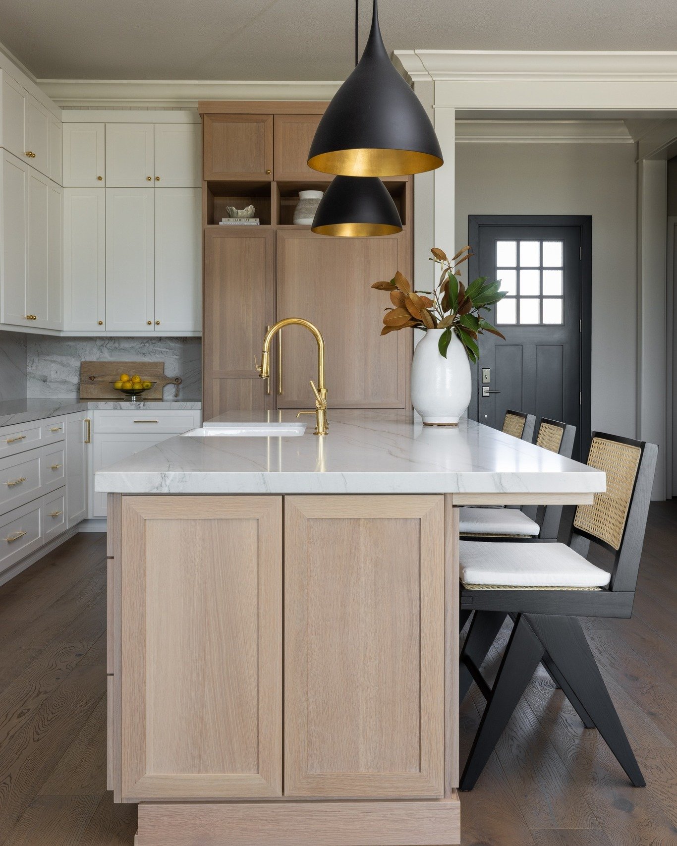 We love two-toned cabinets in larger kitchens. In our El Dorado Hills remodel, a combination of painted white cabinetry with rift white oak breaks up the run of cabinetry on the long back wall and add interest to the island. The painted white cabinet