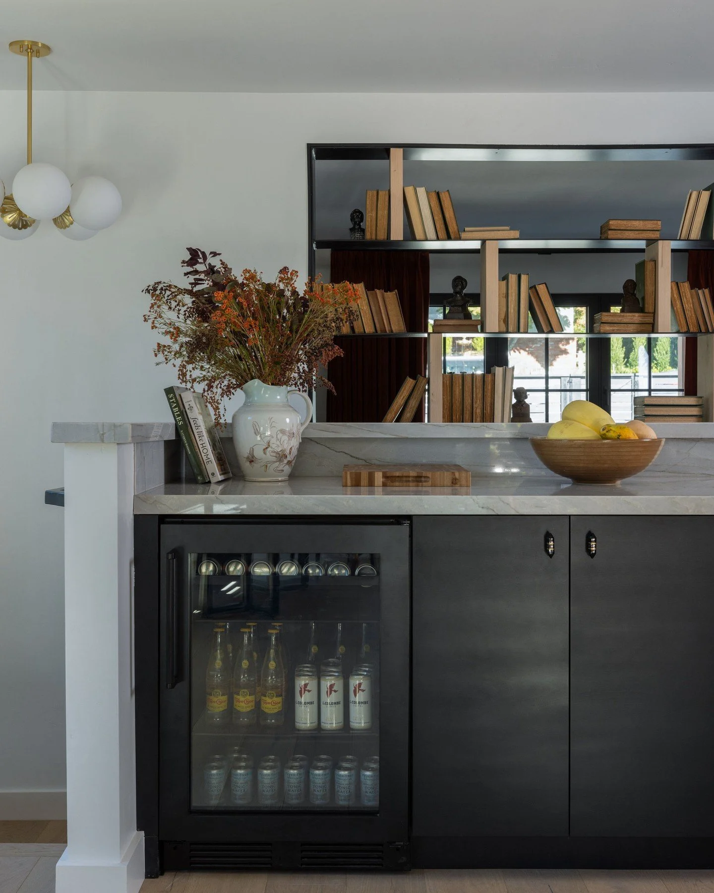 We stained the alder cabinetry a rich charcoal black to preserve the wood&rsquo;s texture and warmth. Add in earthy tones, glam lighting, and a sleek metal passthrough, and you&rsquo;ve got a whole vibe. 🖤

📸: @nicolediannephoto
Styling by: @whitne