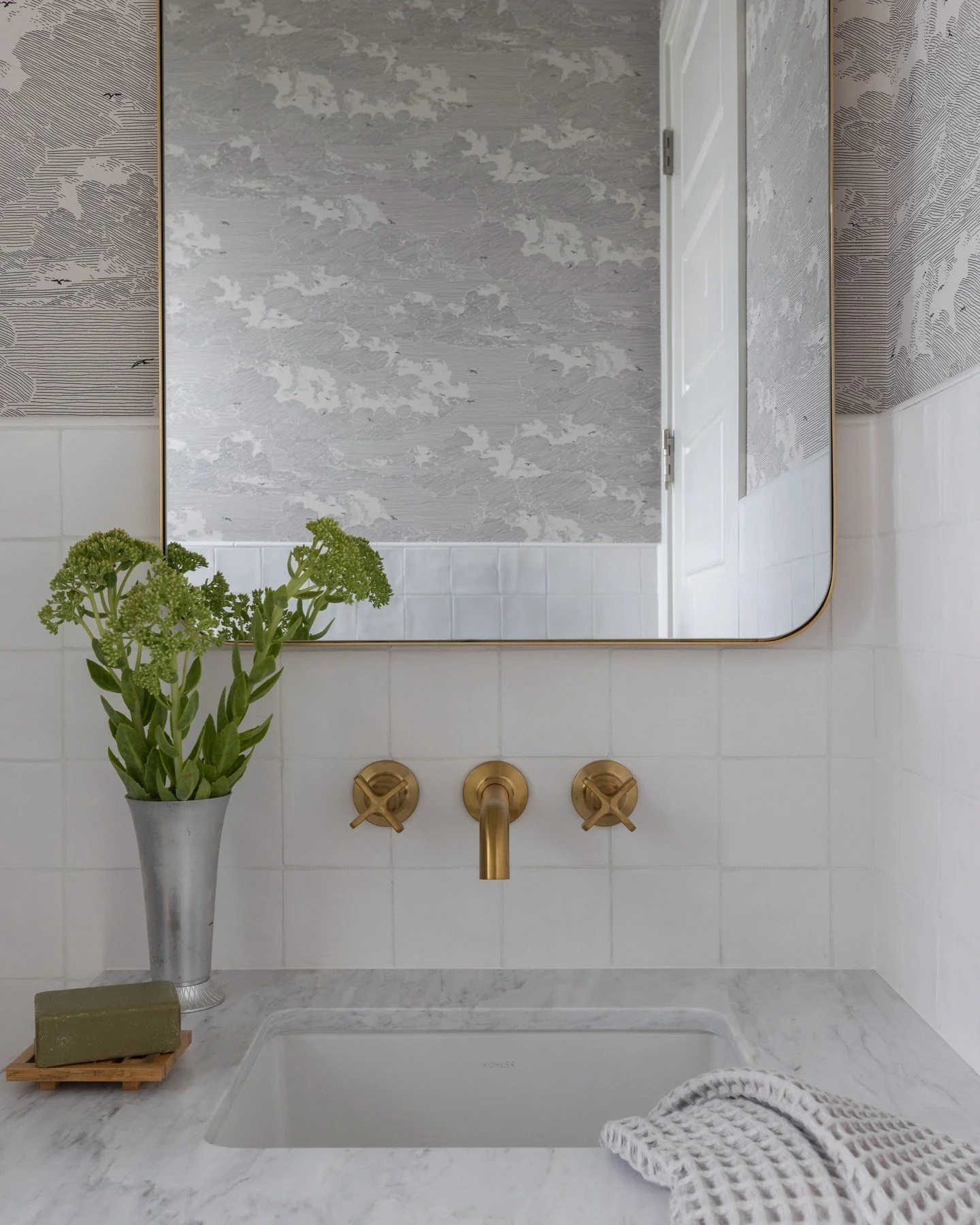 Our formula for the perfect powder room: a beautiful stone vanity, brass fixtures, and a little wallpaper moment. ☁️ 
📸: @nicolediannephoto
Stylist: @emilyairoso