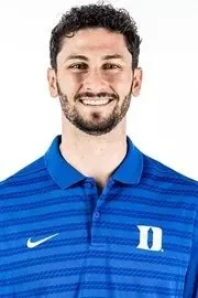 Smiling man wearing a white BC Track & Field polo shirt.