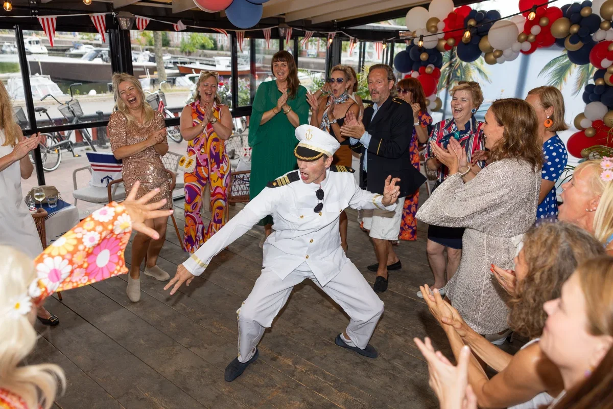 Mies esiintyy vauhdikkaasti lavalla tapahtumassa ja naiset taputtavat