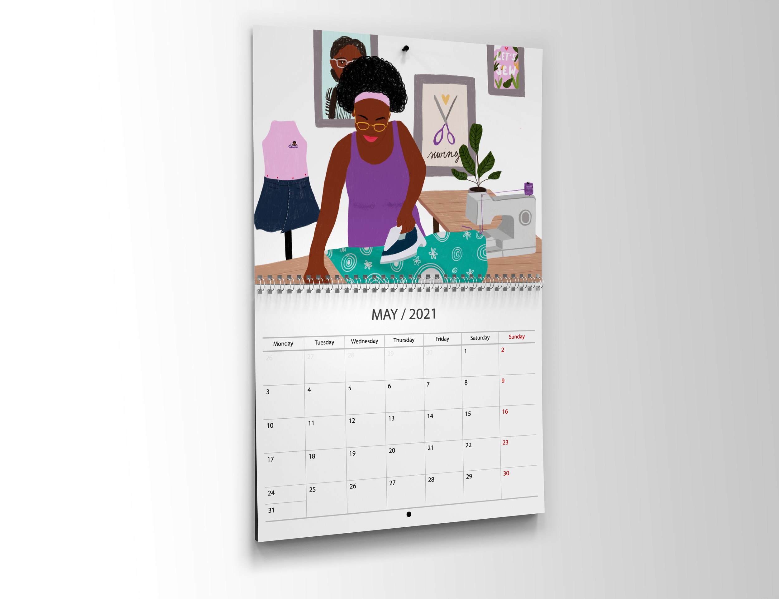 Wall calendar for May 2021 featuring an illustration of a woman sewing.