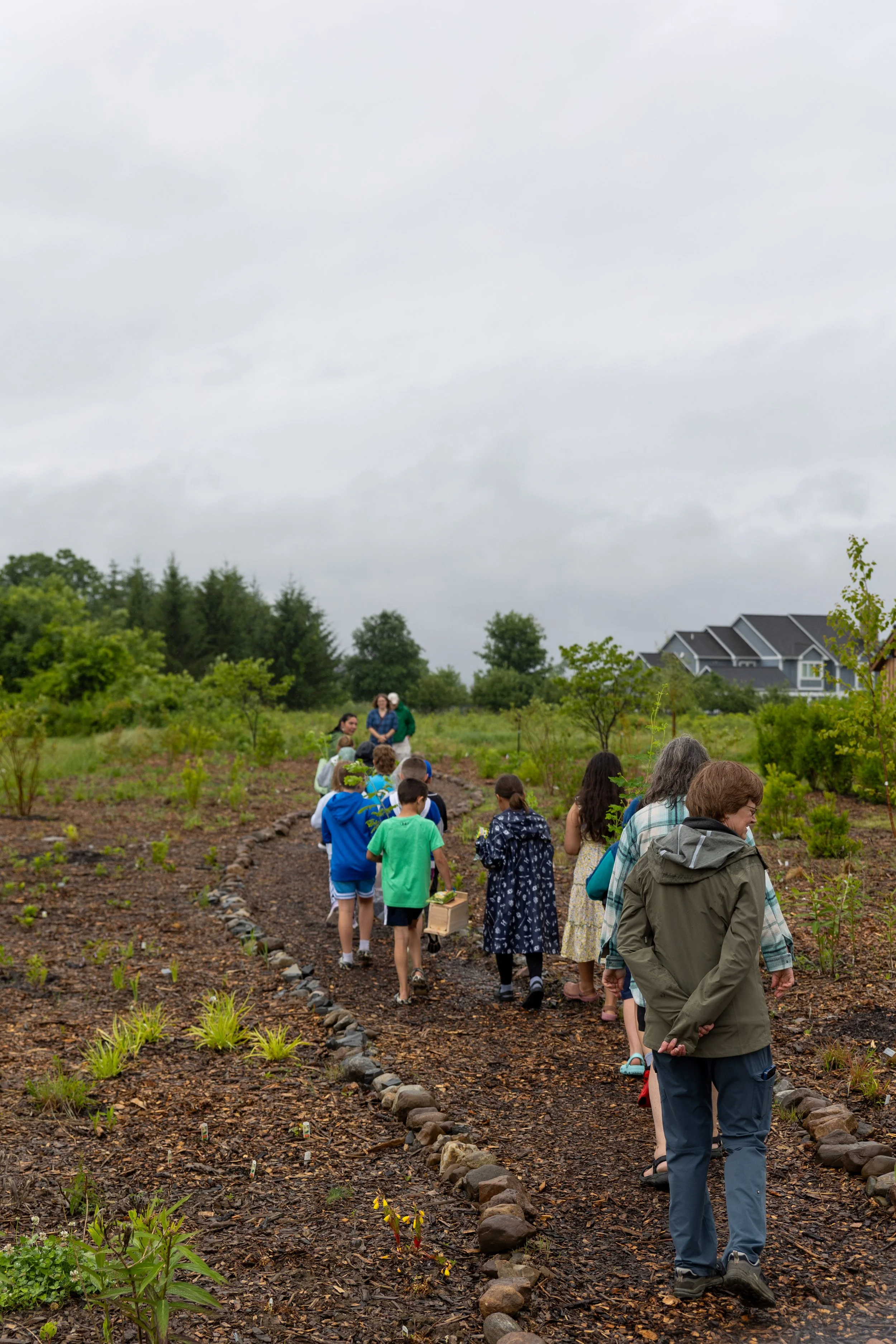  Students walk the new trailhead opening with their teacher, Malloy Bailey. 