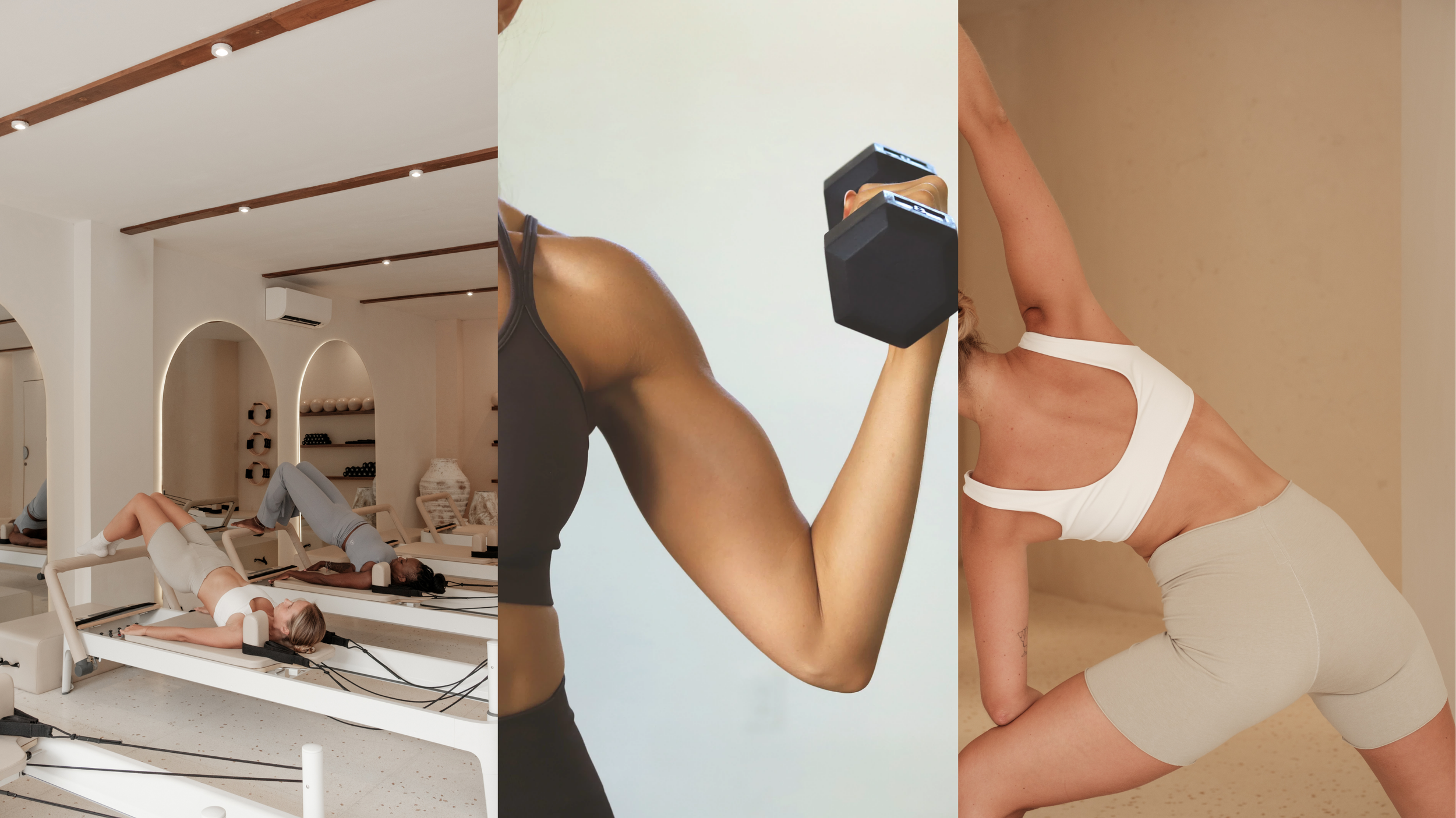 Close-up side view of a woman in a white cutout sports bra and beige workout shorts, stretching in a studio with a neutral-toned wall.