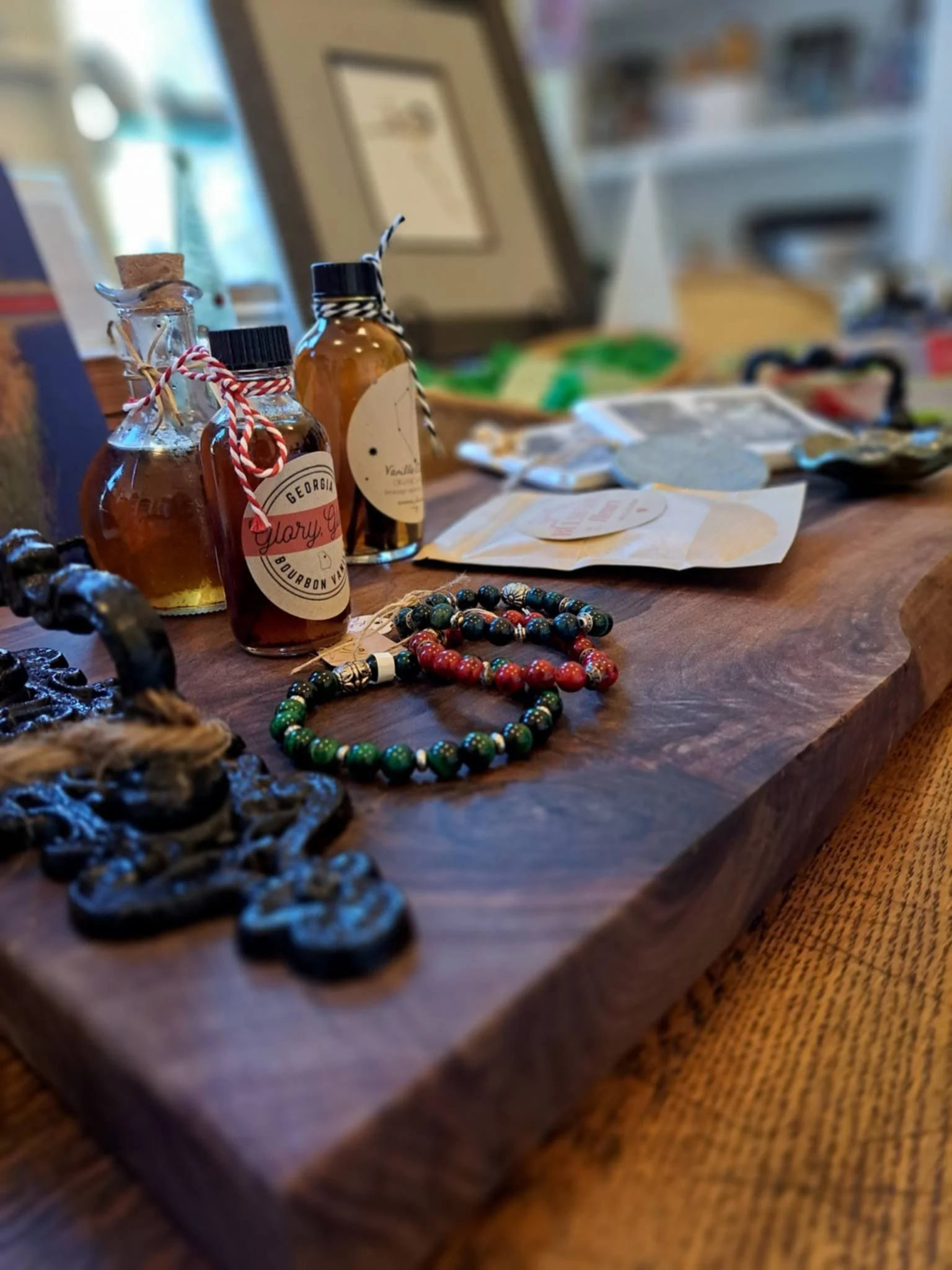 Photograph includes a close up of shop items including bracelets, homemade vanilla, and more.