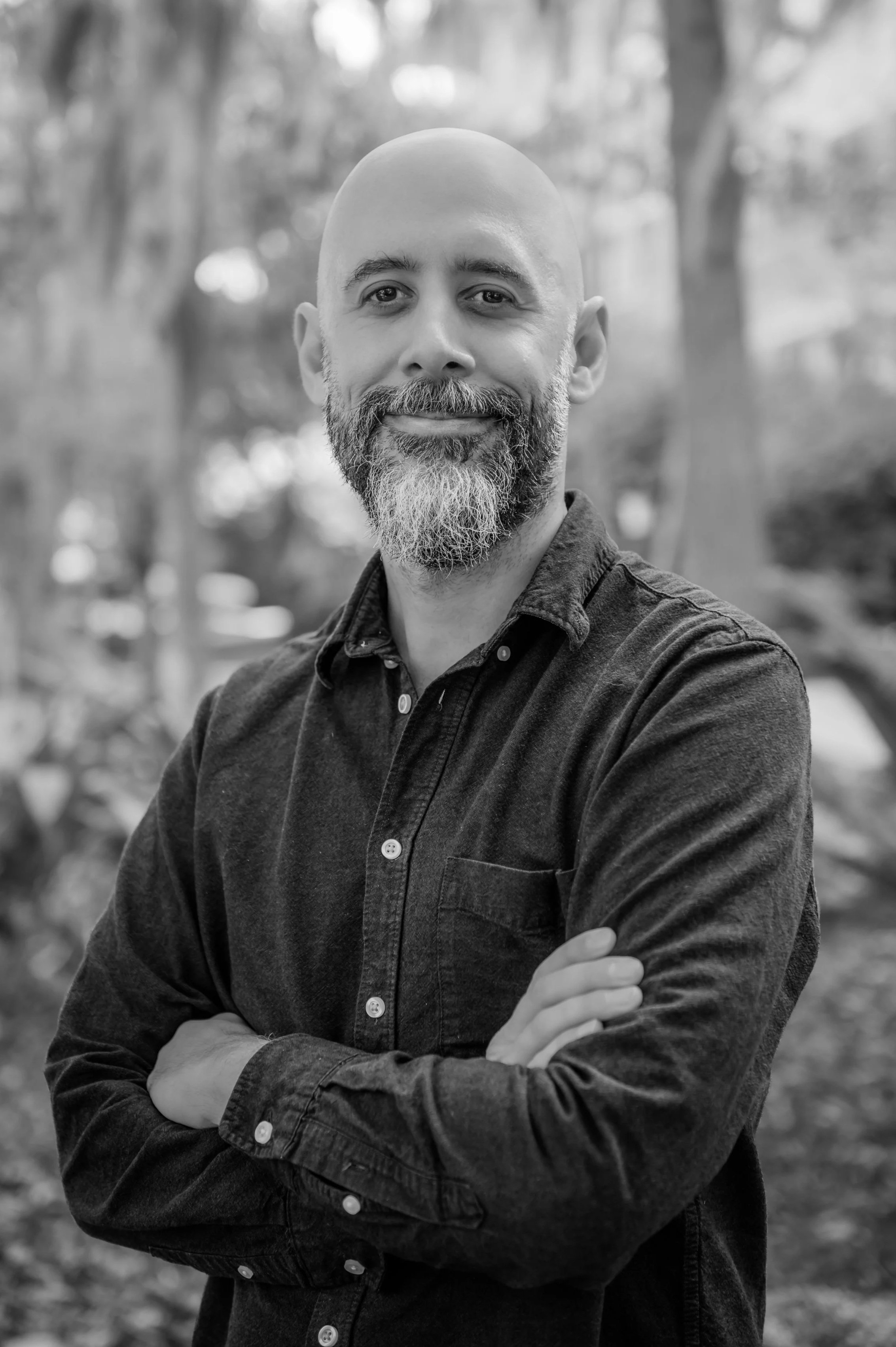 headshot photo of matias raby looking directly at the camera; a brick background