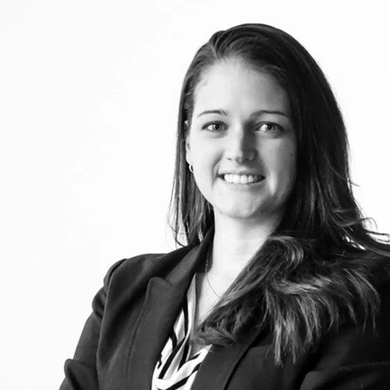 black and white headshot of casey bissell with white background; looking directly at camera