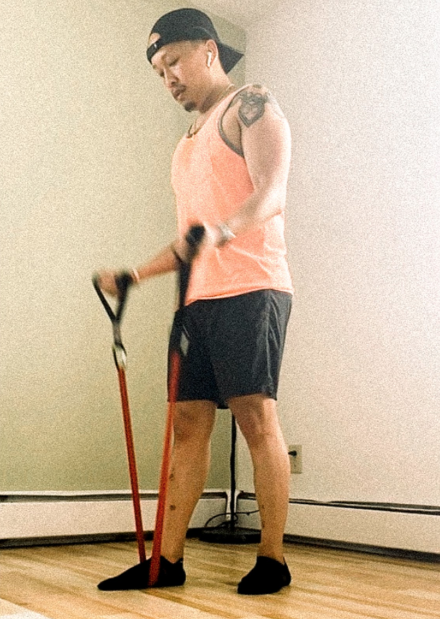 Toubee doing an at-home workout with resistance bands