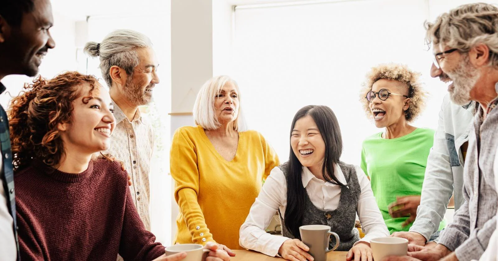 Different generations of people in business working together.