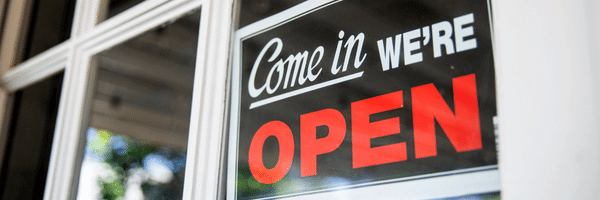 Come in we're open sign on a new business window.