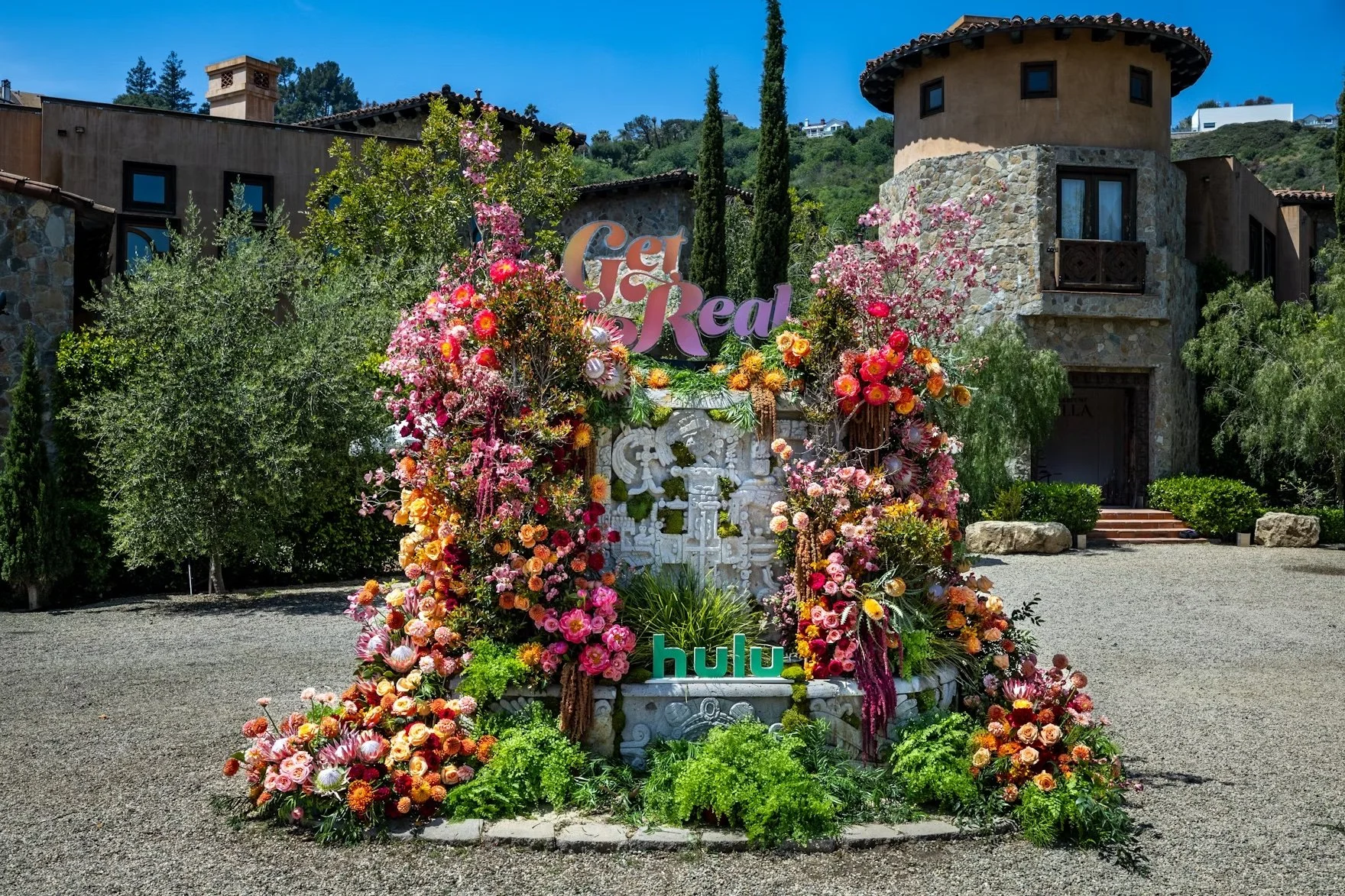 The welcome moment, greeting guests with overflowing with florals and color