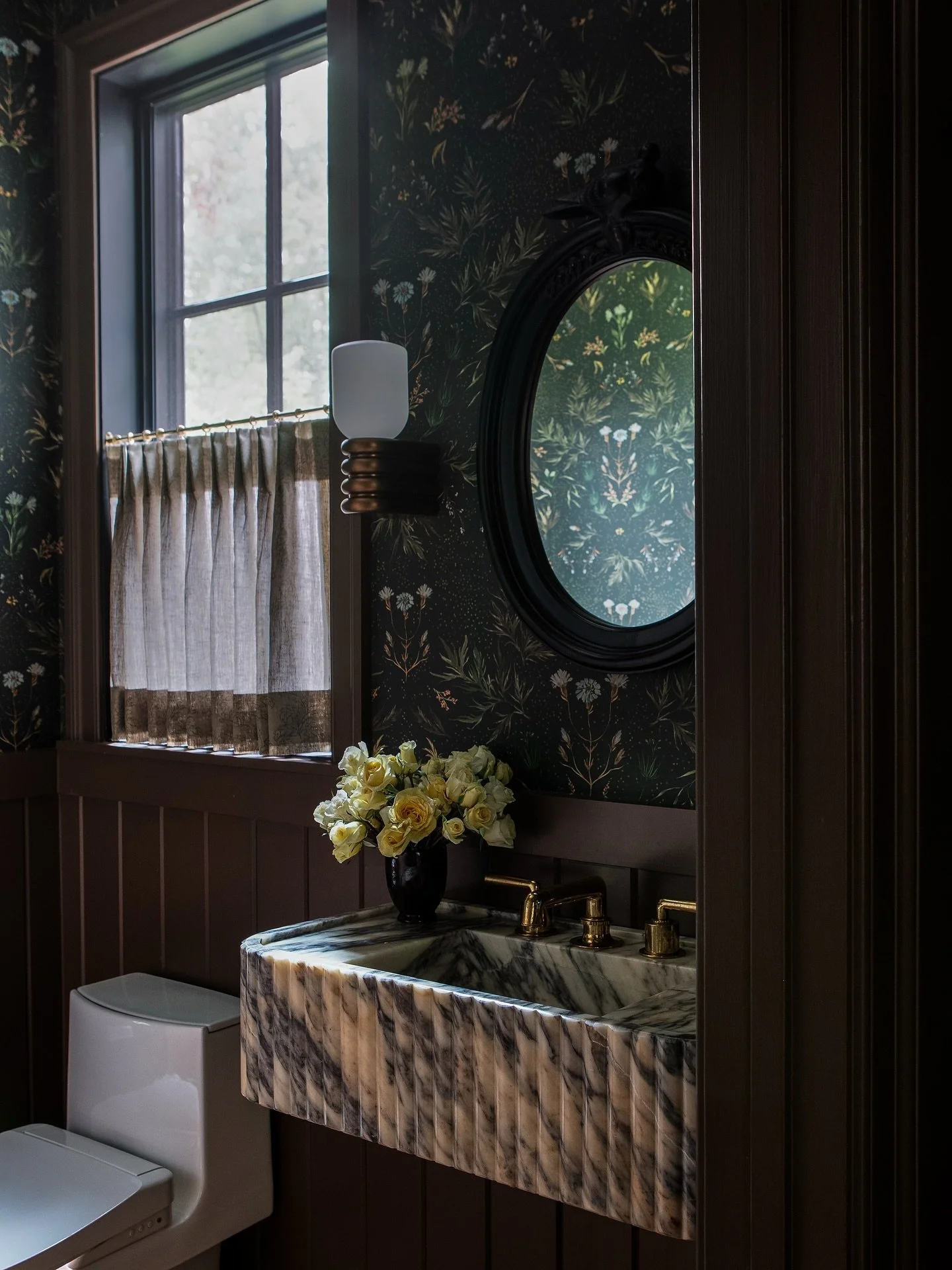 The Edison St powder room blends moody and whimsy with vintage and contemporary touches. What&rsquo;s your favorite&mdash;the marble sink, the wallpaper, or the lights? Photo: @angelanewtonroyphotography Styling: @kristihunter