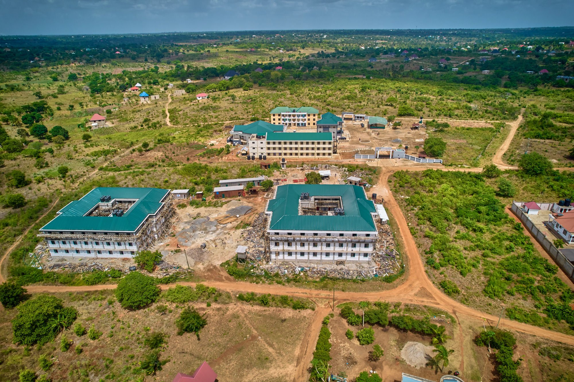 Two new dormitories with classrooms, dining hall and administration in the background.