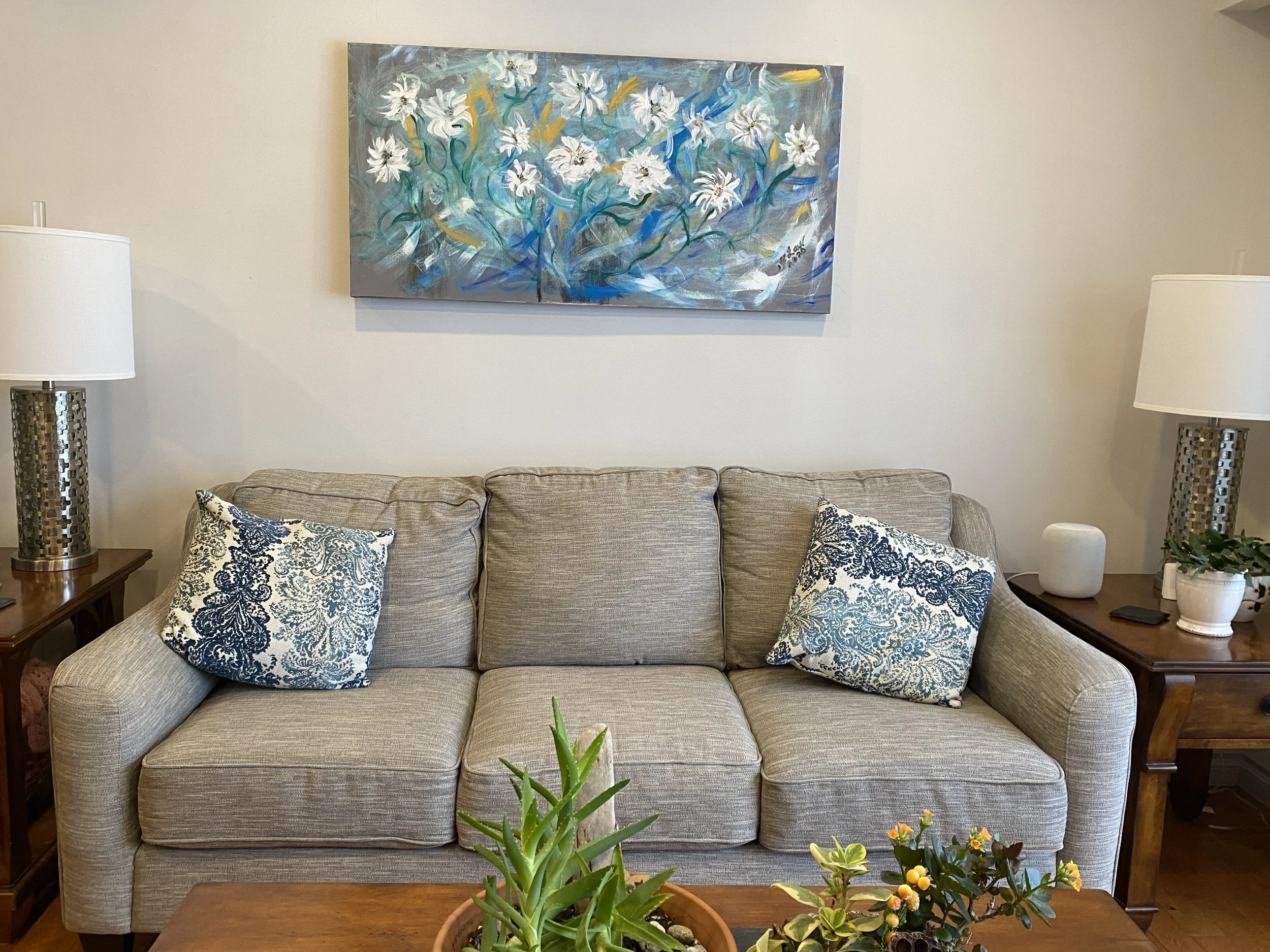 Abstract painting of flowers. Displayed in living room.