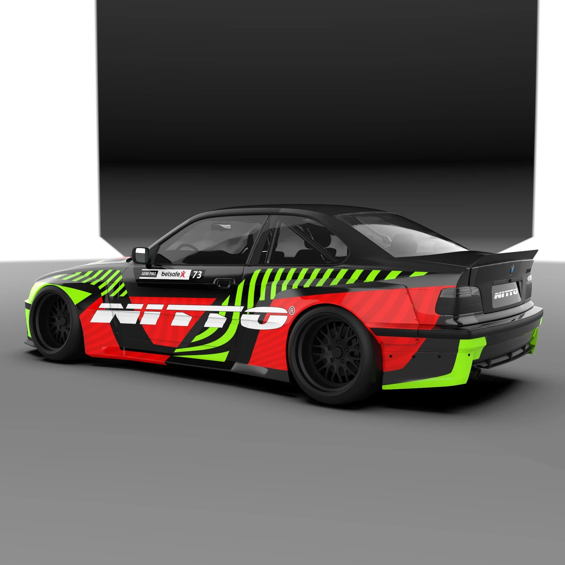 A racing car with black, red, and green graphics and sponsor logos, parked indoors against a two-tone background.