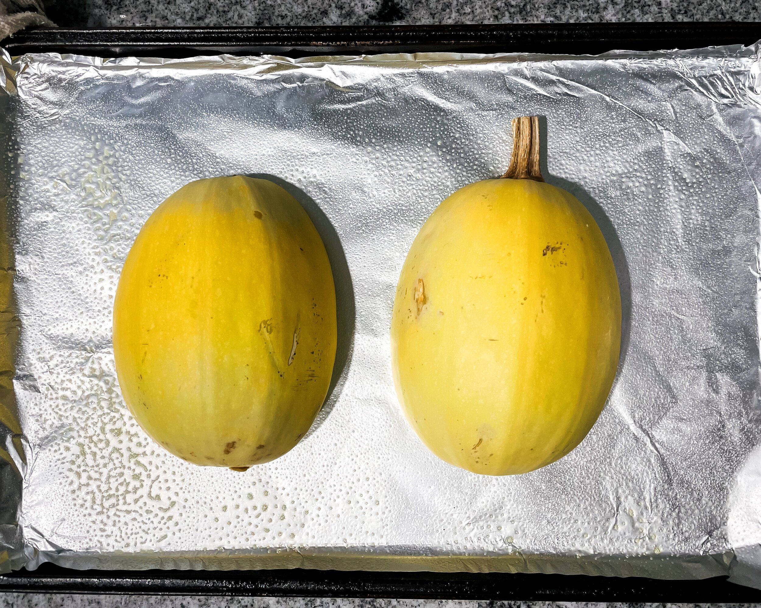 Spaghetti Squash Cut in Half On Baking Sheet