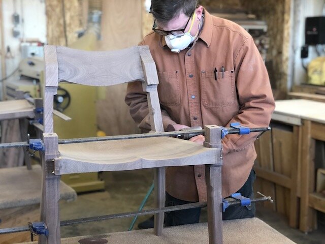Ethan Hutchinson teaching custom wood furniture making classes in a professional wood workshop.