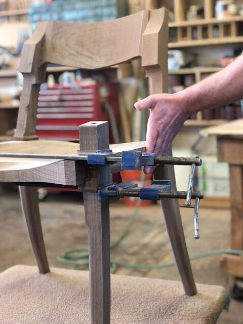 Craftsman building custom dining table furniture in omaha by Ethan Hutchinson in wood workshop