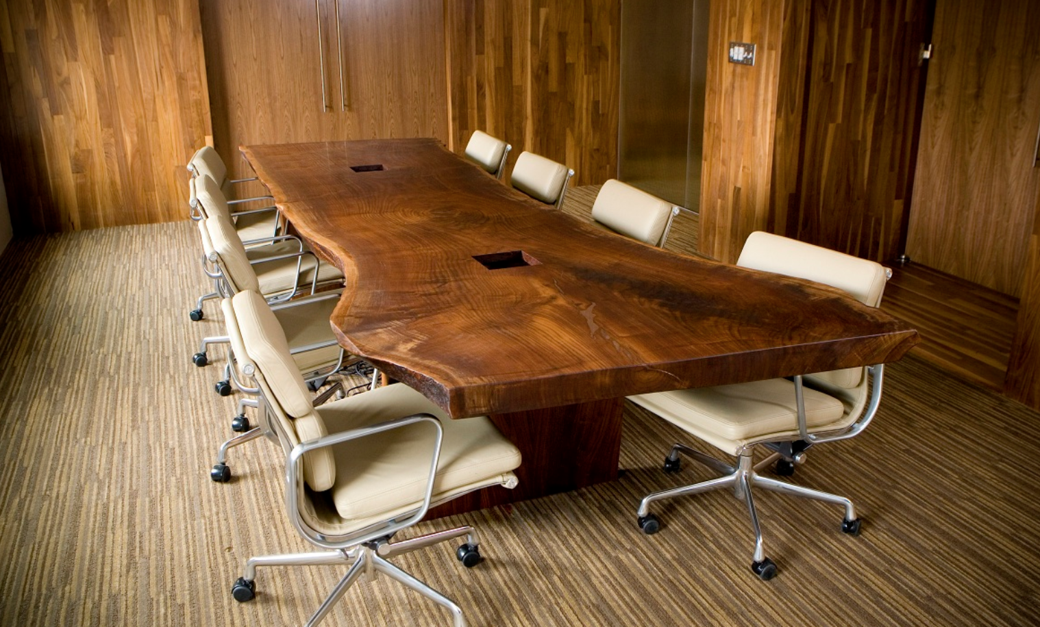 Custom dining table by Ethan Hutchinson showcasing handcrafted custom furniture in modern office space.