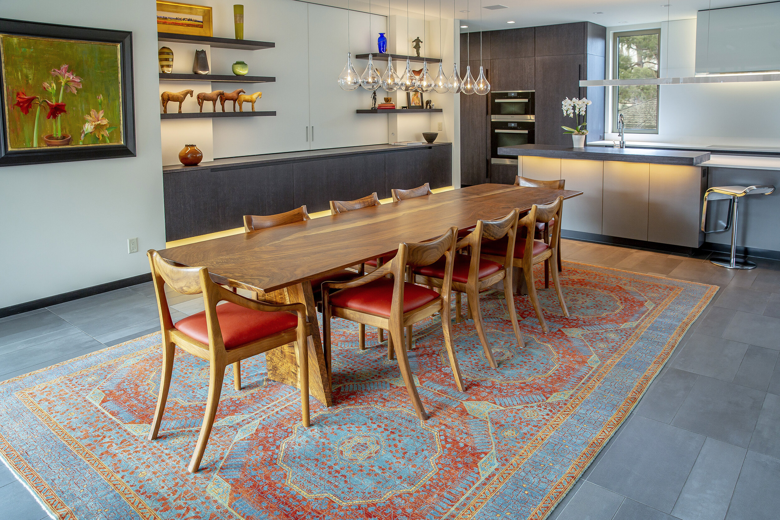 Custom dining table with side chairs by Ethan Hutchinson showcasing custom furniture in modern space.