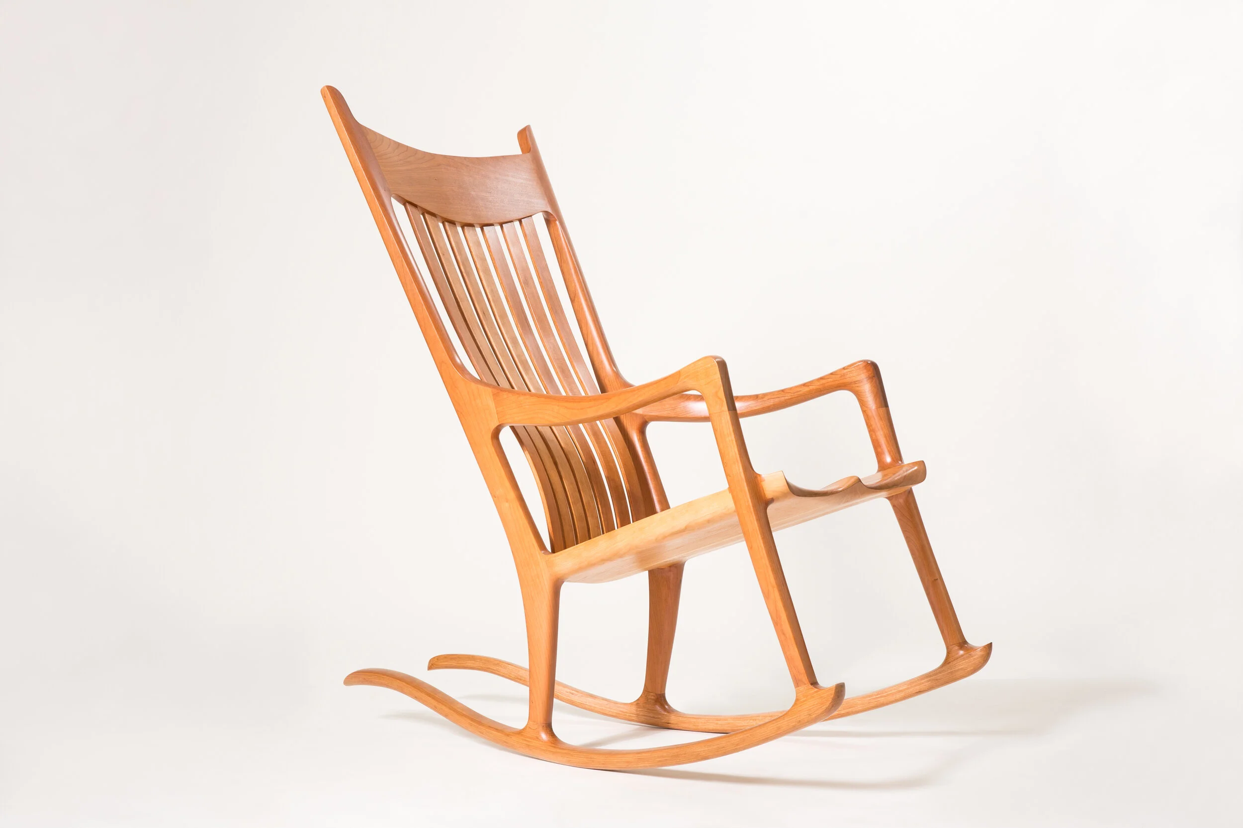 Custom wood furniture Hutchinson Rocker showing handcrafted wood rocking chair with curved base in our furniture store