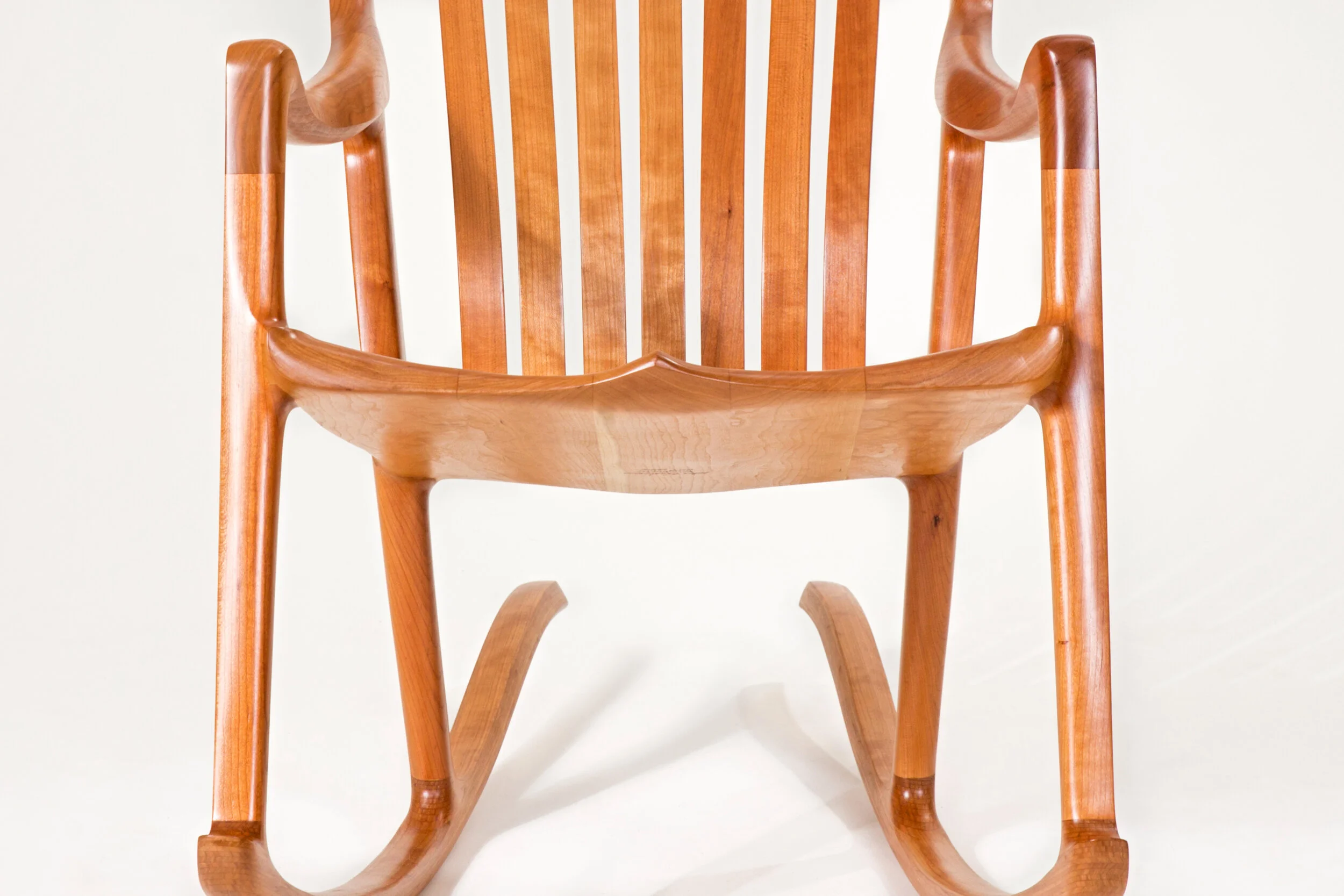Close-up of Hutchinson Rocker wood rocking chair with handcrafted seat and leg design in our our furniture store