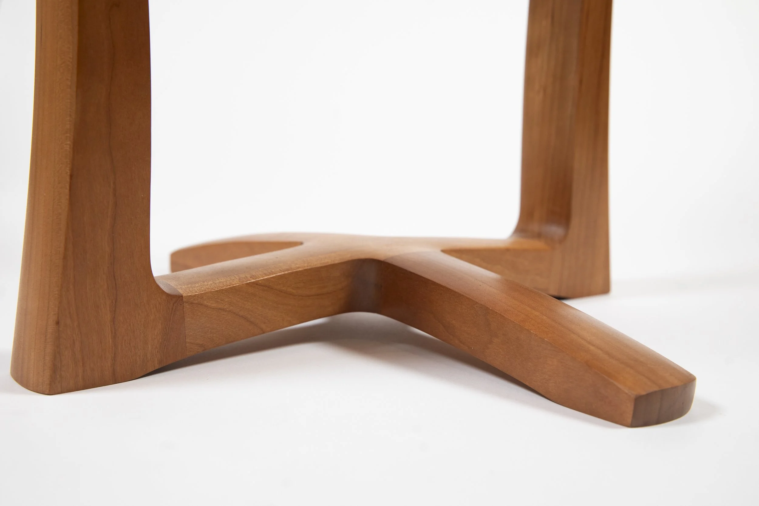 Close-up of handcrafted custom  side wood table base with smooth joinery details in online furniture store
