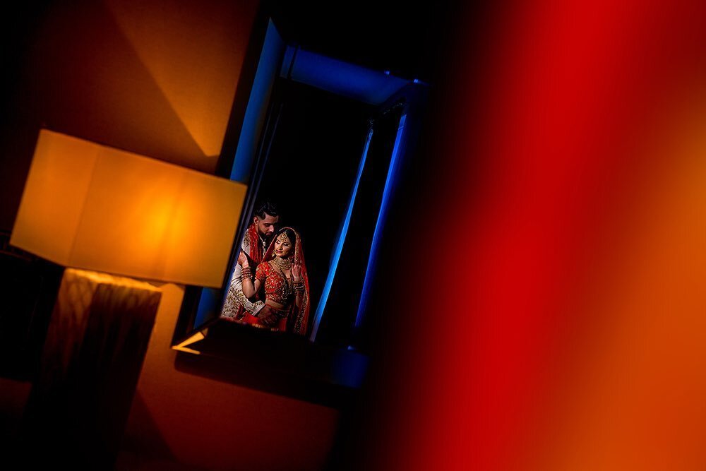 &lsquo;Reflecting&rsquo; back to Hanisha and Ram&rsquo;s wedding day. Here&rsquo;s a picture I made by switching off the lights in a bedroom and using a mirror to frame the couple. Like many creative photographers, this is one of my favourite parts o