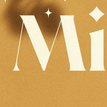 Cream sans-serif letters "Mi" with star accents on a warm mustard background. The design is beautiful, but the contrast between the cream and mustard isn't strong enough to meet WCAG standards.