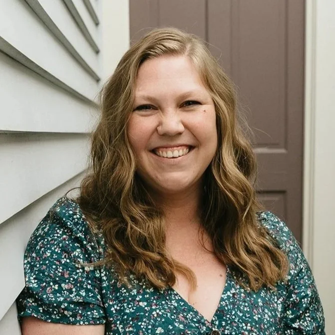 Julia, a white woman with dirty blonde hair is smiling.