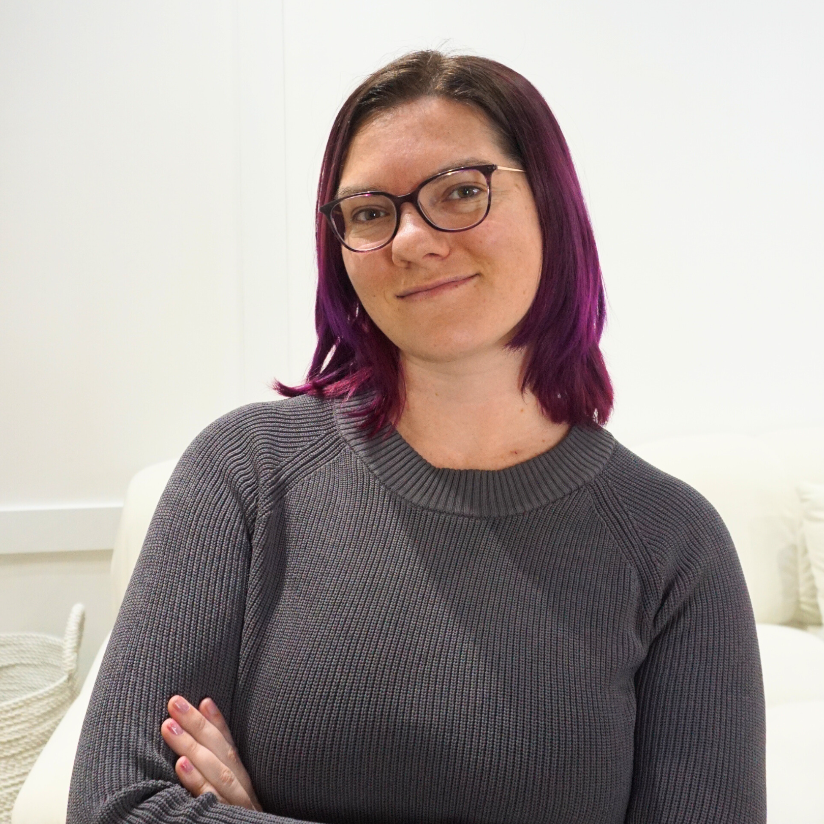 Nina Clapperton, a white woman with chin length hair wearing glasses.