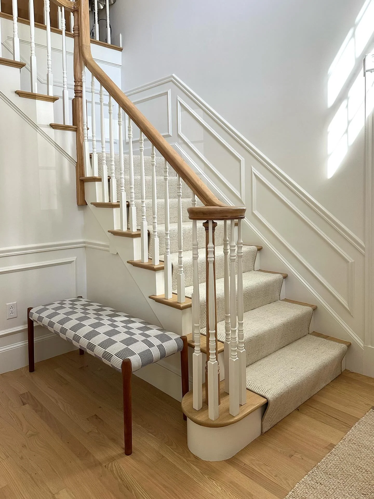 Super happy with how the entryway at #modernyetmuted is turning out. Swipe to see what it looked like before the wood floors and handrail were sanded and sealed. A new runner adds fresh modernity to the space, and we had my client&rsquo;s vintage ben