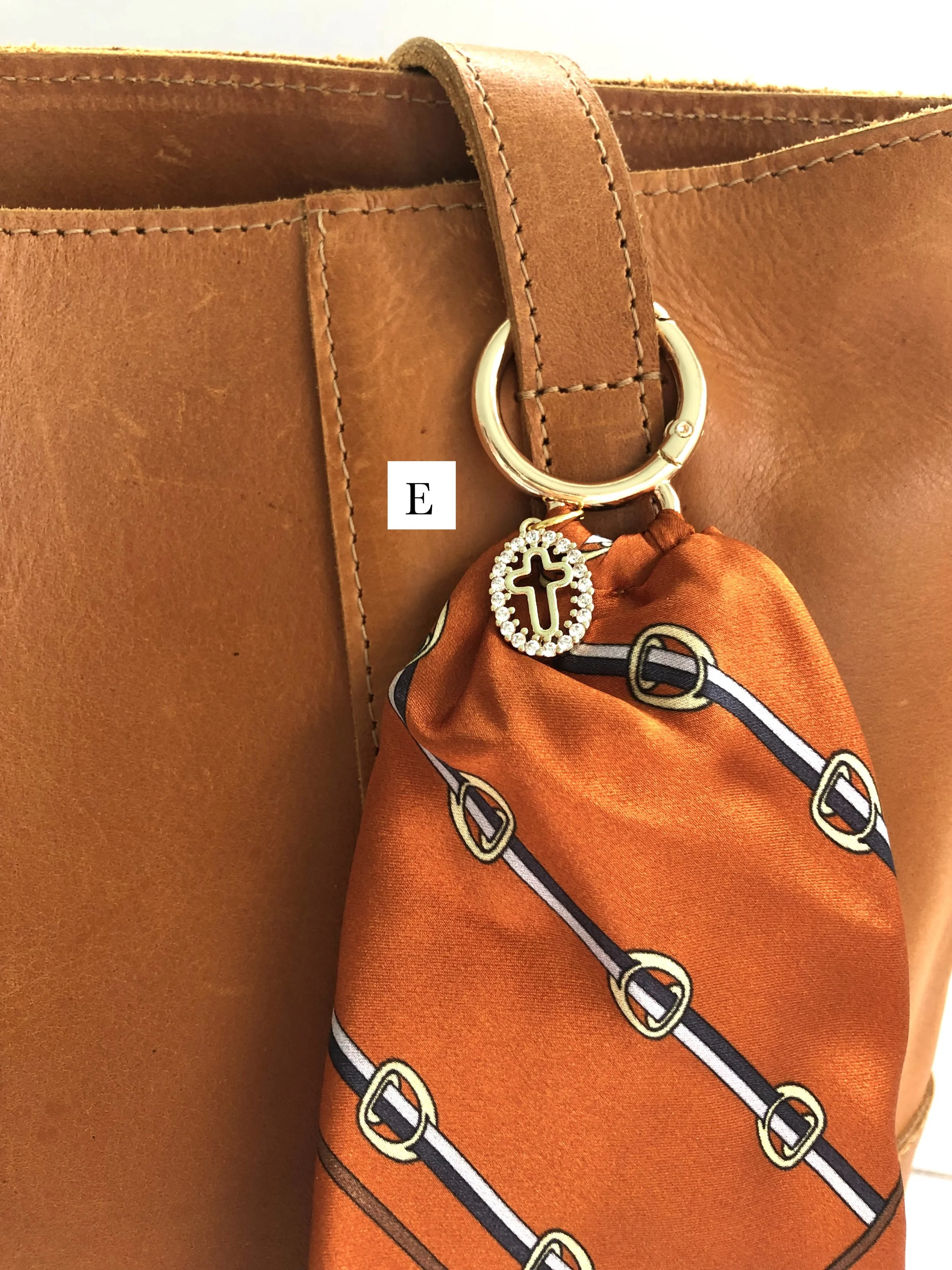 E_Orange_Buckle_OvalCrossCharm_OnBag_PH2 copy.jpg