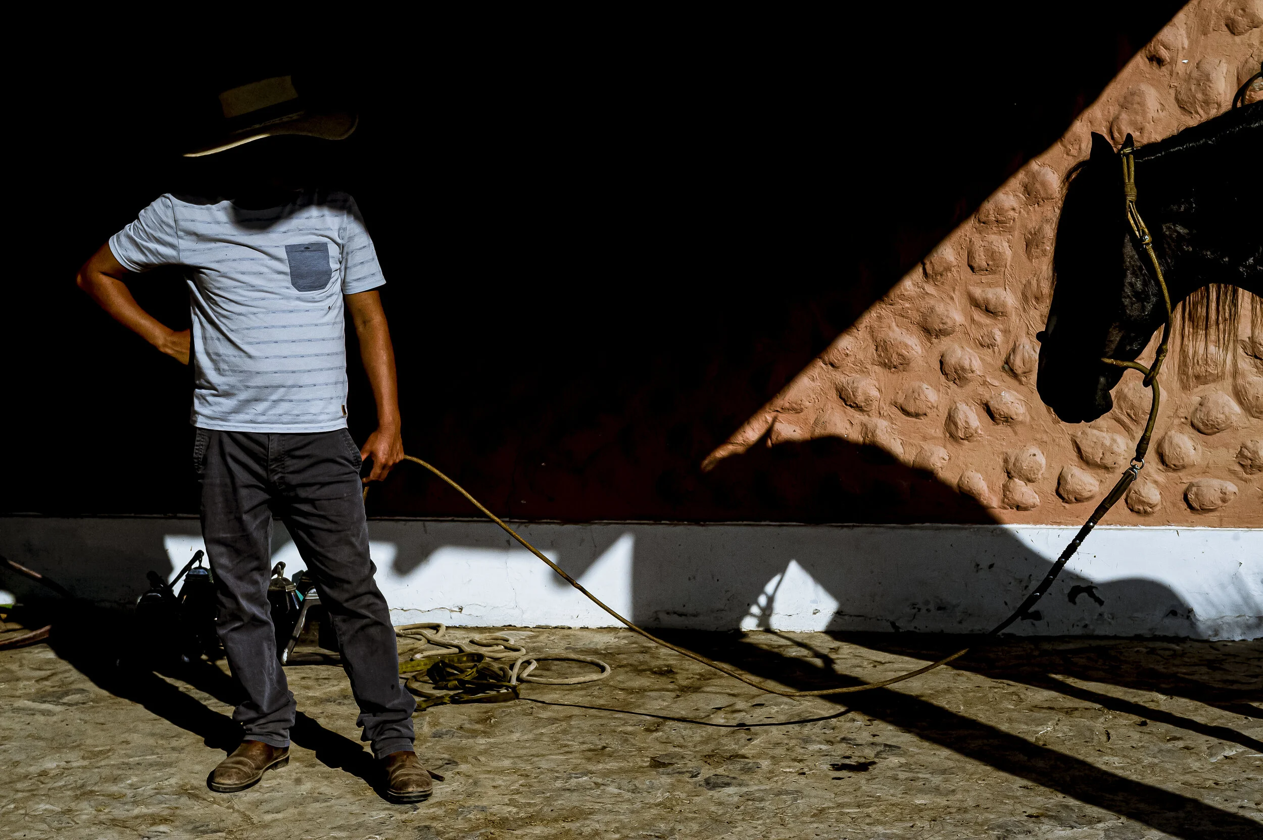  A rancher rests before leading out his employers horse during the a national competition for horse pageantry in Lima, Peru, on April 12, 2018.  