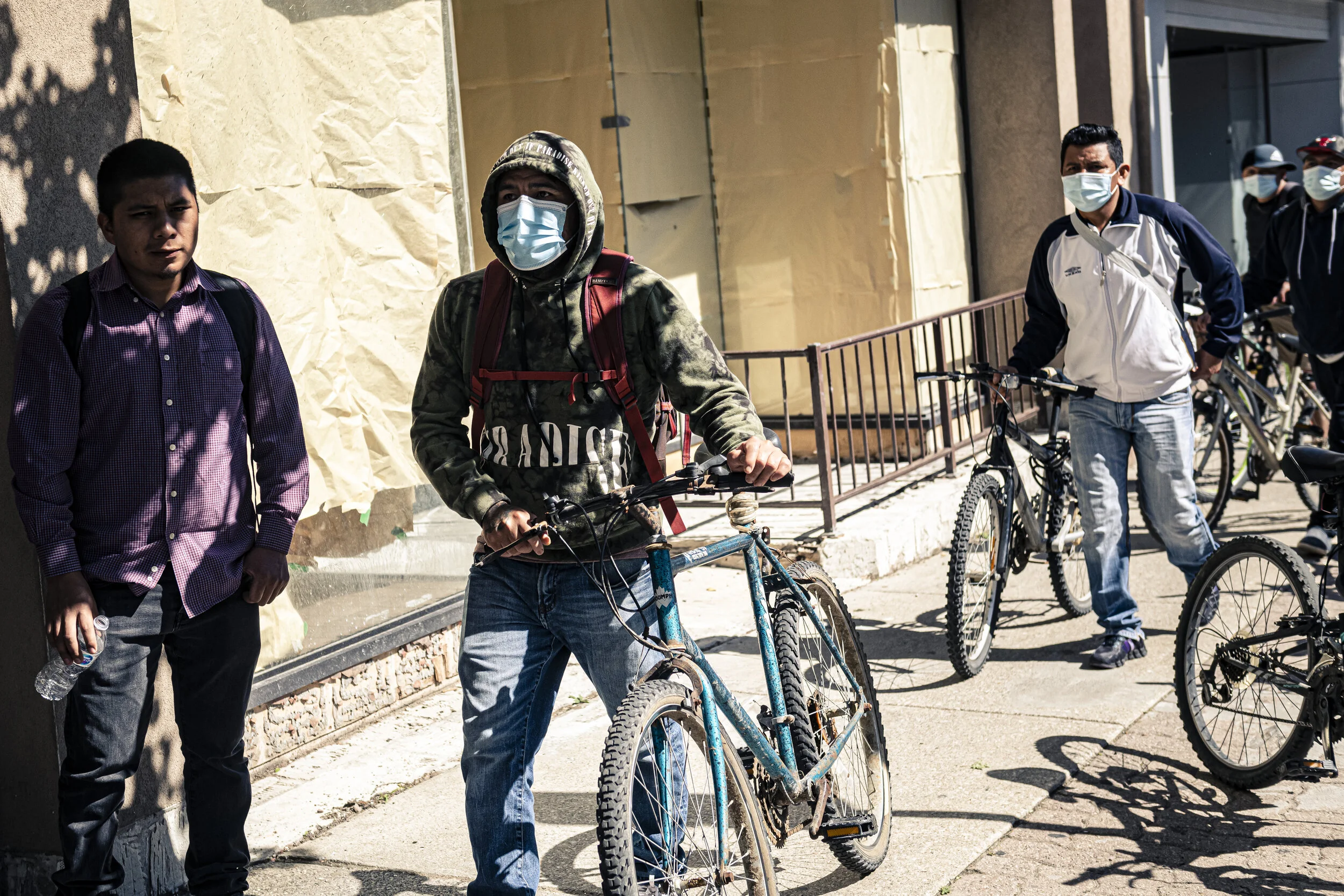  Farmworkers walk their bikes through downtown Leamington, Canada, on June 14,  2020.  