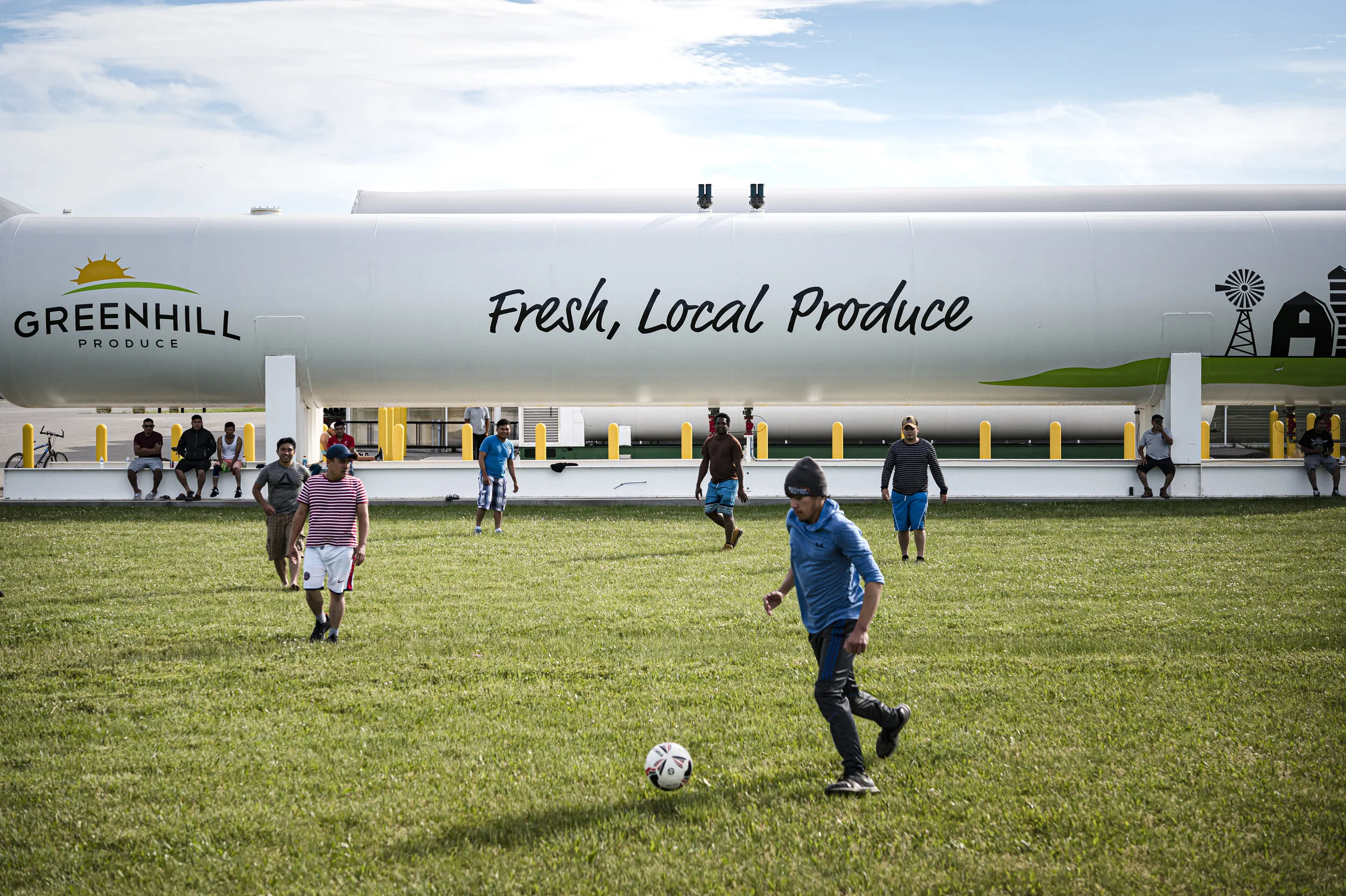  Migrant workers play a game of soccer on the front lawn of Greenhill farms, in Kent Bridge, Canada, on June 7,  2020. At the peak of the Covid-19 outbreak at Greenhill farms there were 103 positive cases of the illness and one death.   