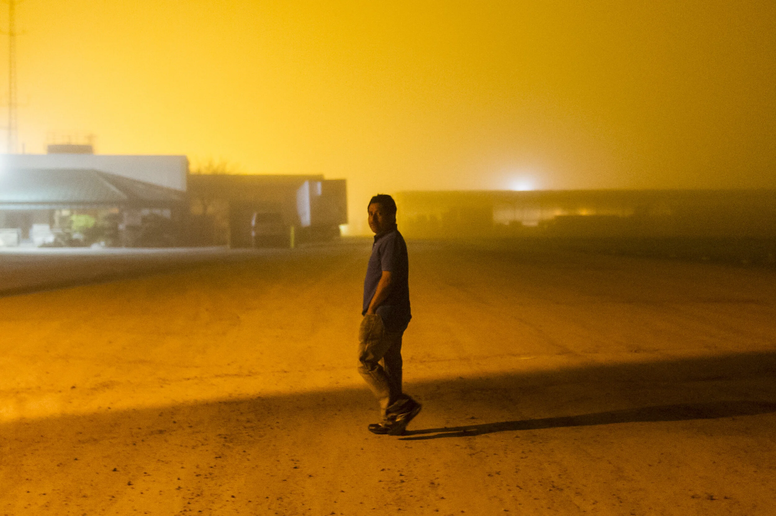   A worker takes one last look at his workplace and home for the last 7 years before being deported to Guatemala the following day, in Leamington, Ont., on May 17, 2015. 